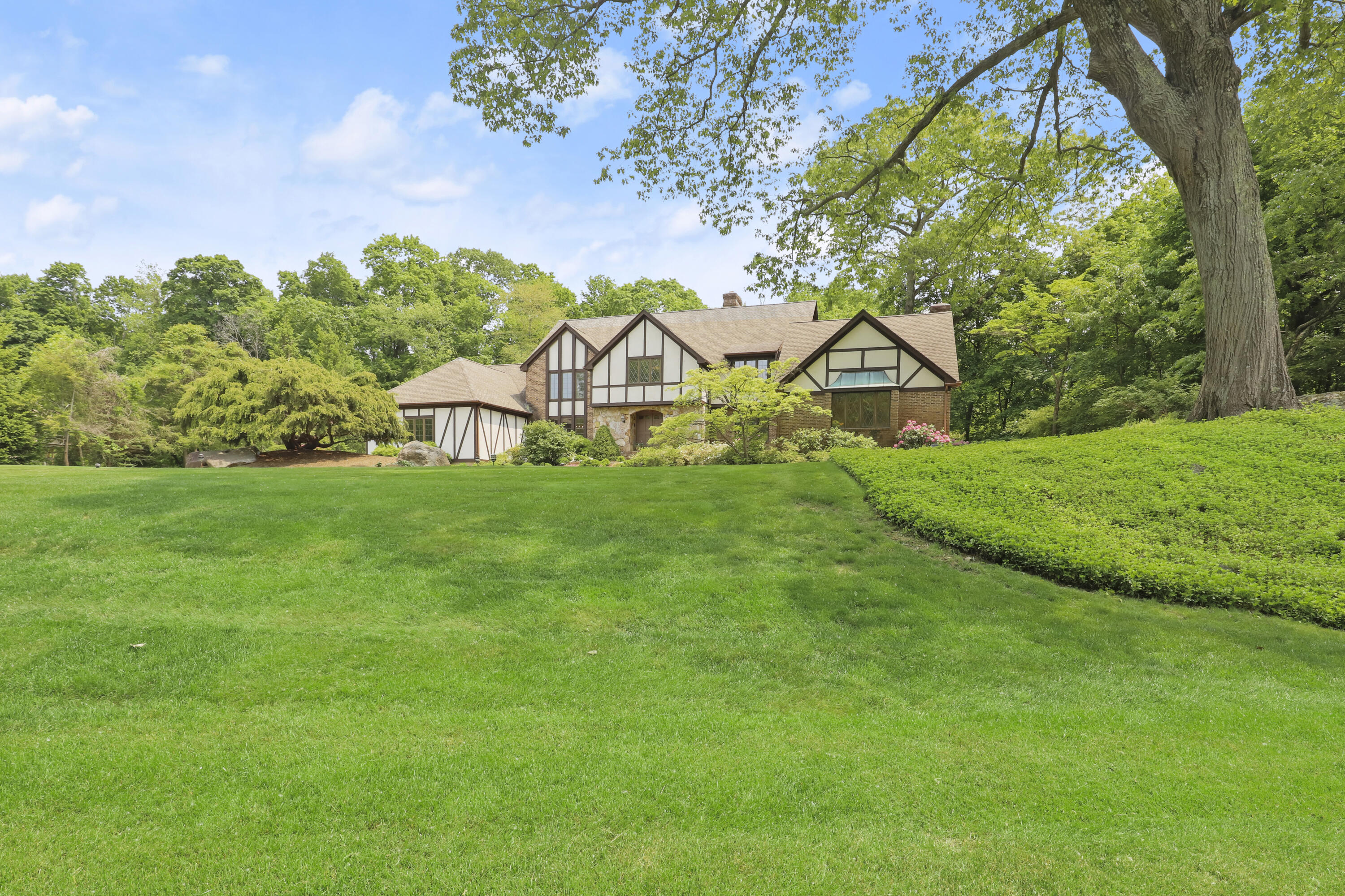 37 Long Lots Road New Canaan, CT 06840 - Photo 5 of 42 a view of a house with a big yard and large trees