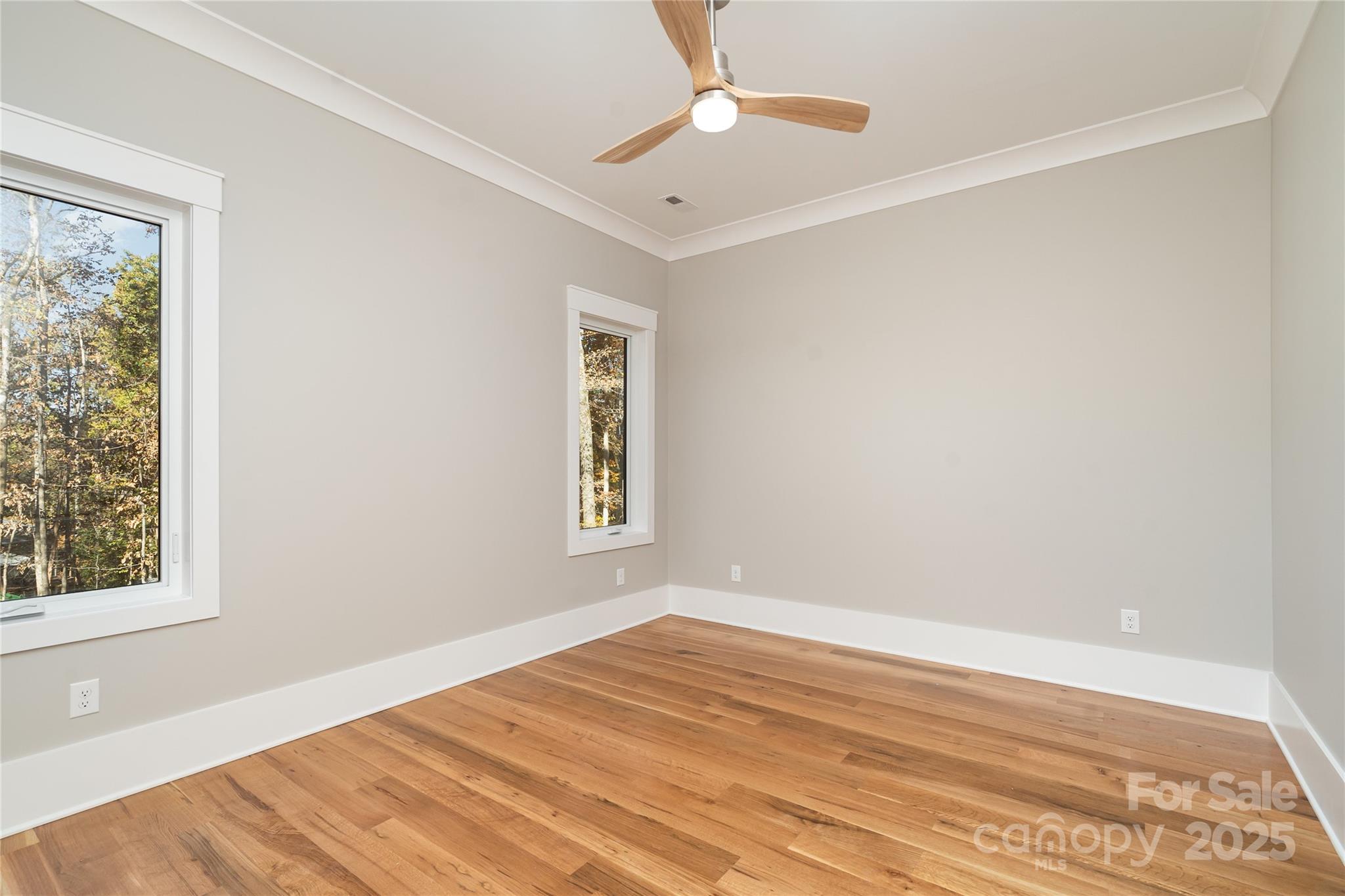 6632 Silver Fox Road Charlotte, NC 28270 - Photo 17 of 42 a view of empty room with wooden floor and fan