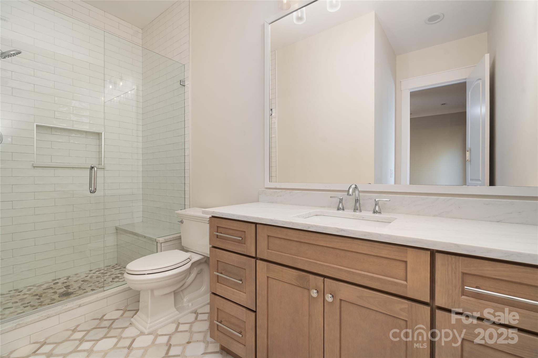 6632 Silver Fox Road Charlotte, NC 28270 - Photo 18 of 42 a bathroom with a granite countertop toilet sink and mirror