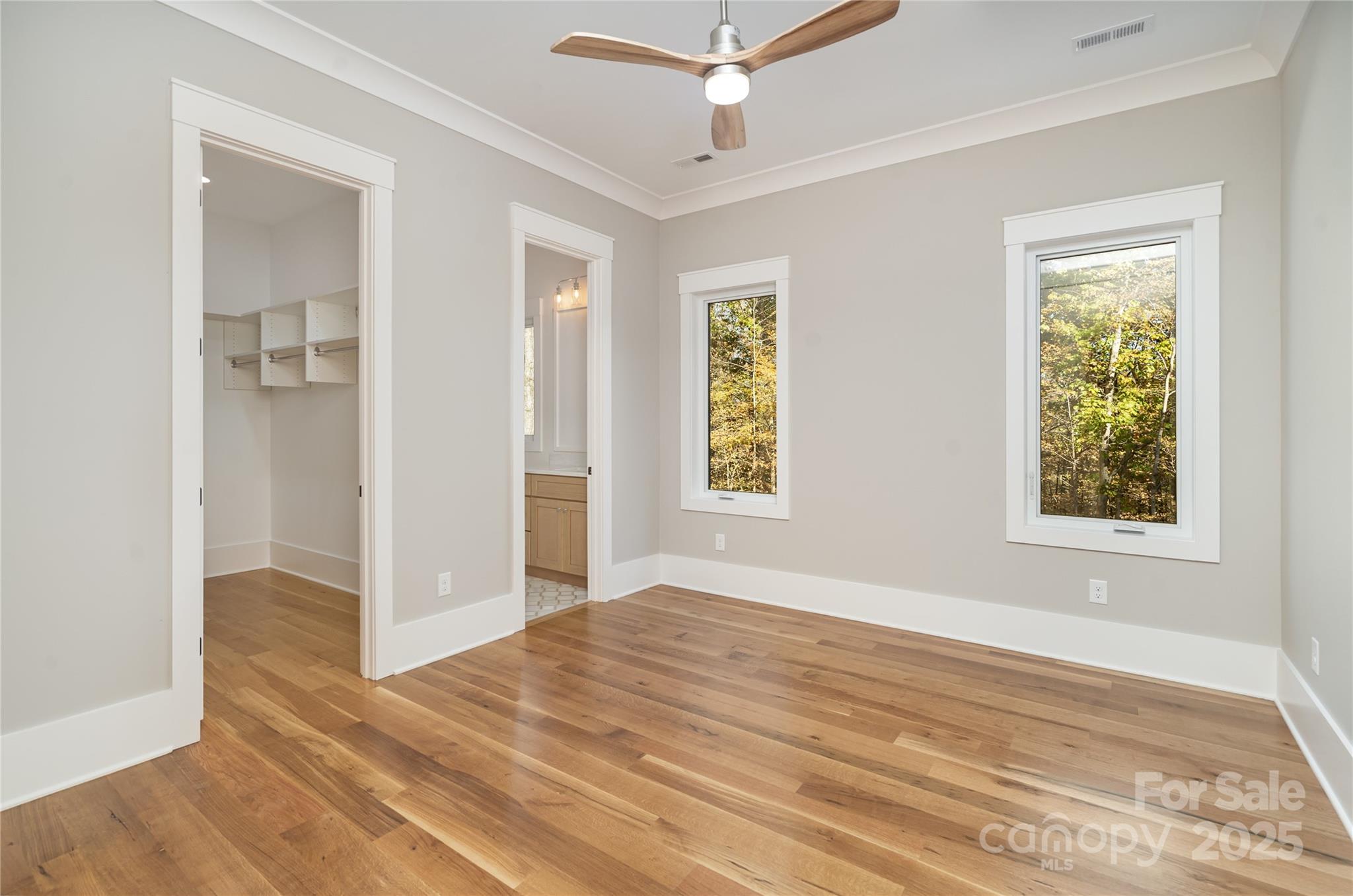 6632 Silver Fox Road Charlotte, NC 28270 - Photo 19 of 42 a view of empty room with wooden floor and fan