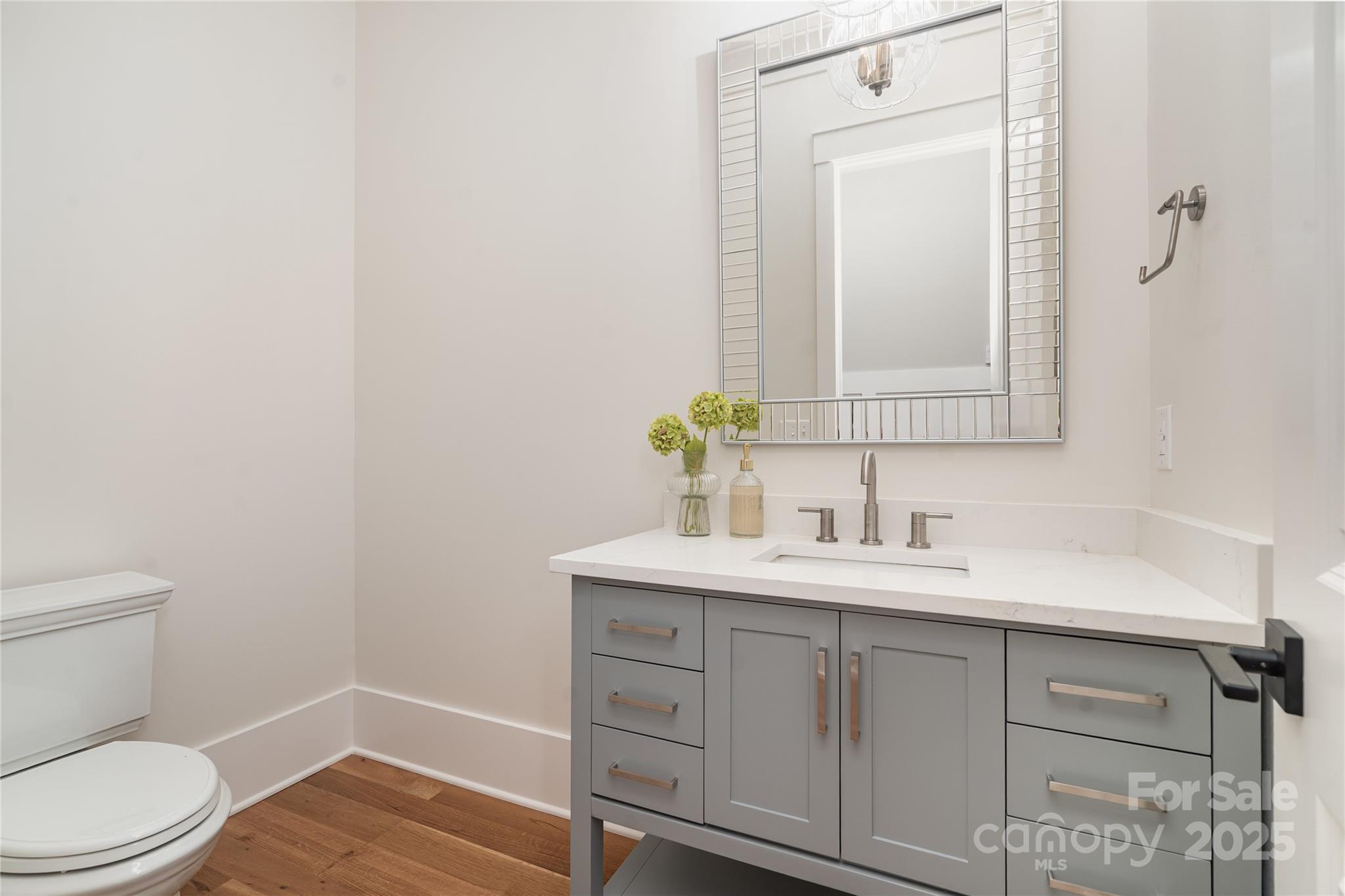 6632 Silver Fox Road Charlotte, NC 28270 - Photo 20 of 42 a bathroom with a toilet a sink a vanity and mirror