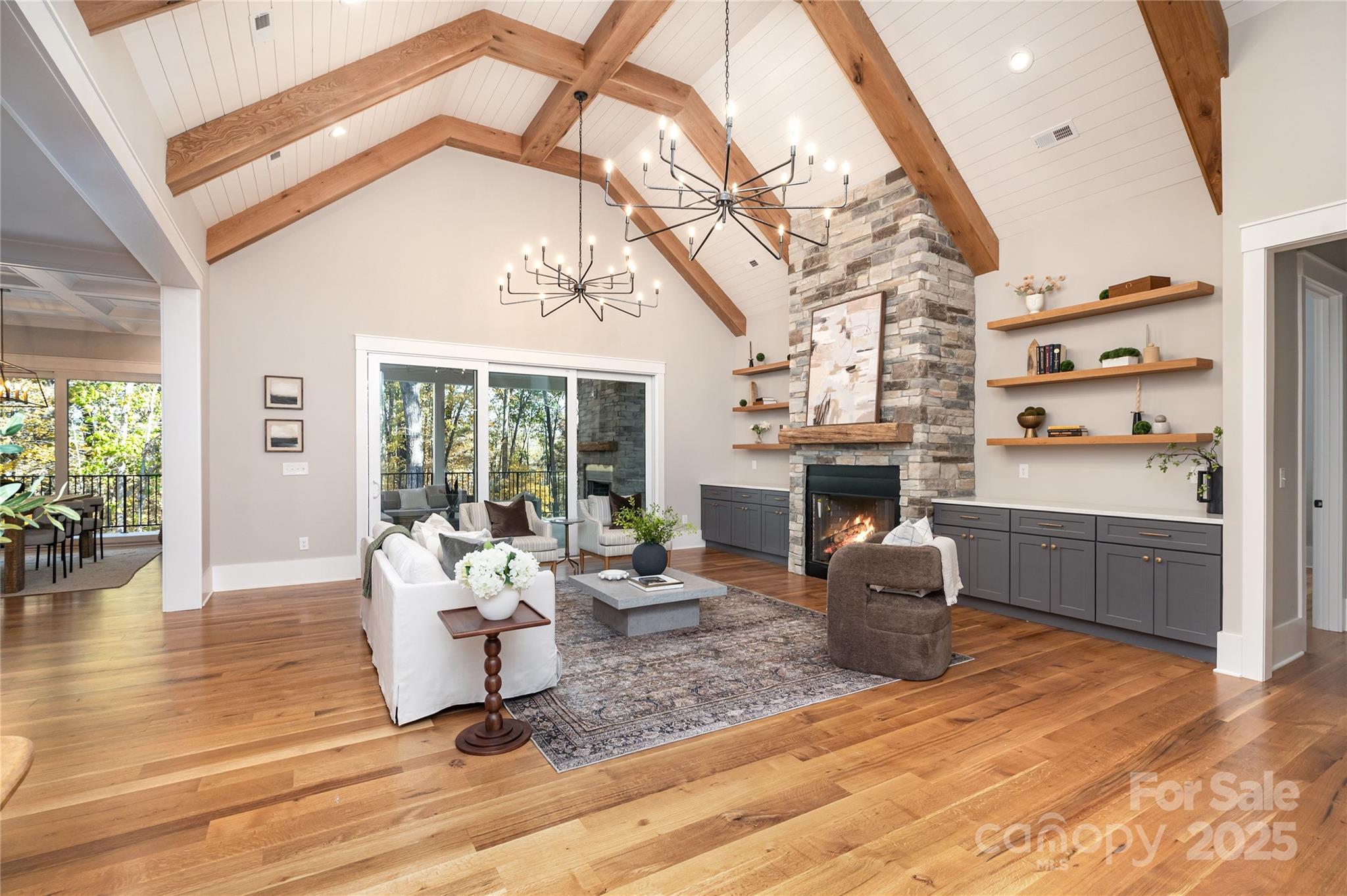 6632 Silver Fox Road Charlotte, NC 28270 - Photo 2 of 42 a living room with furniture a fireplace and a floor to ceiling window