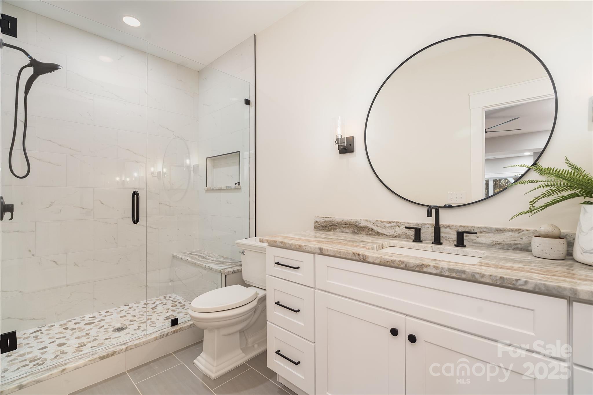 6632 Silver Fox Road Charlotte, NC 28270 - Photo 22 of 42 a bathroom with a sink a toilet and a mirror
