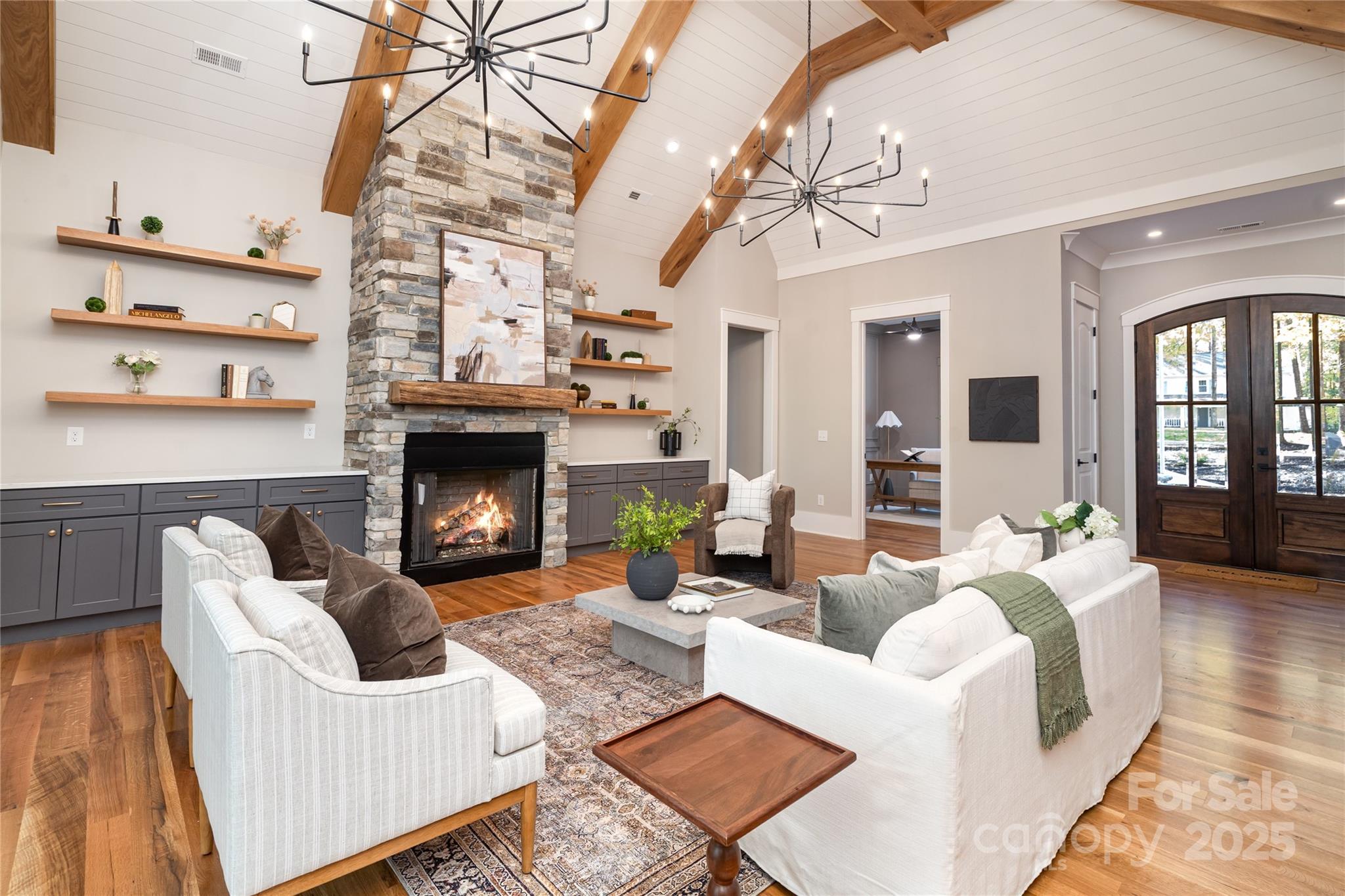 6632 Silver Fox Road Charlotte, NC 28270 - Photo 3 of 42 a living room with furniture a fireplace and a chandelier