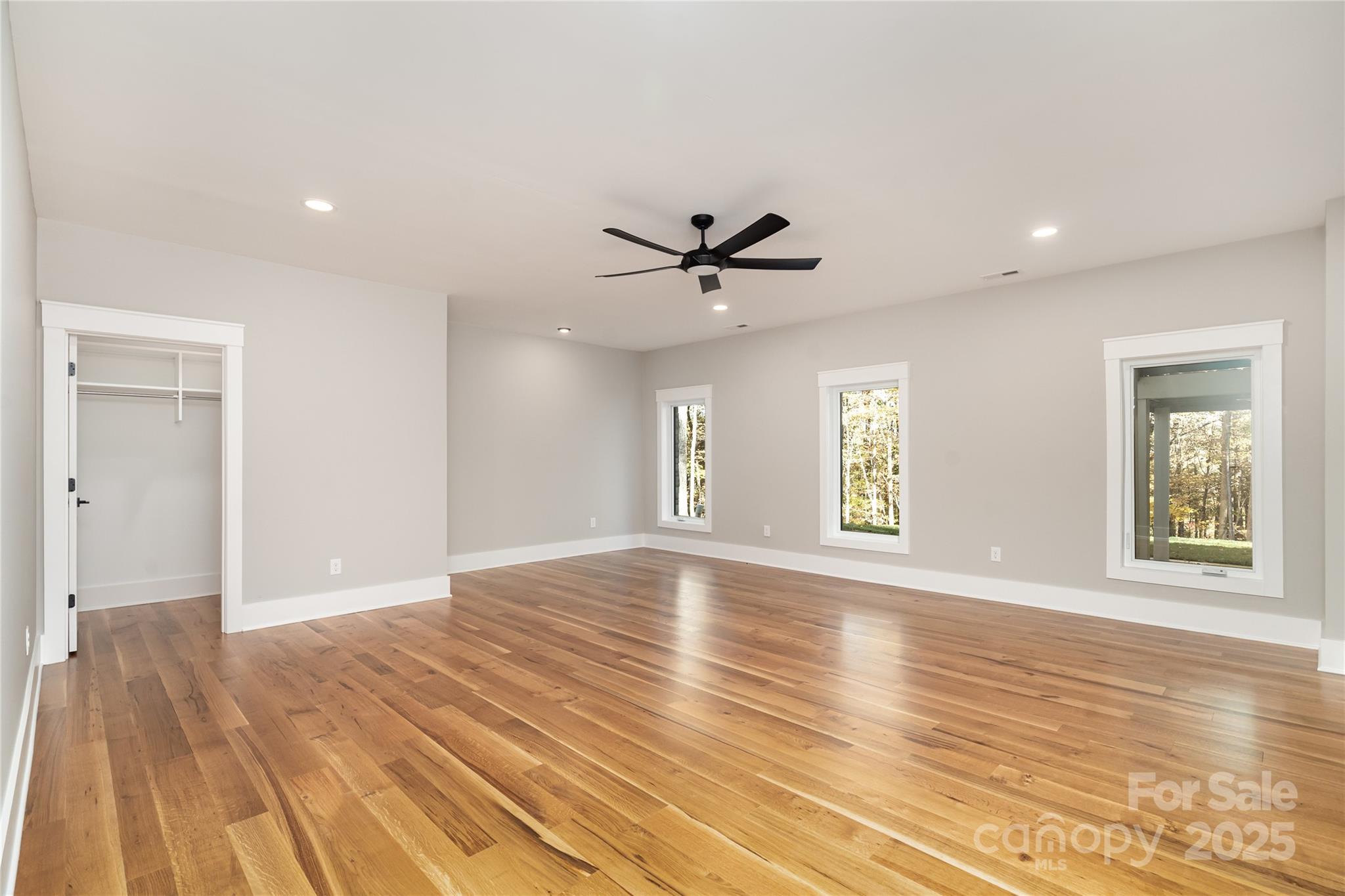 6632 Silver Fox Road Charlotte, NC 28270 - Photo 33 of 42 a view of an empty room with a window and wooden floor