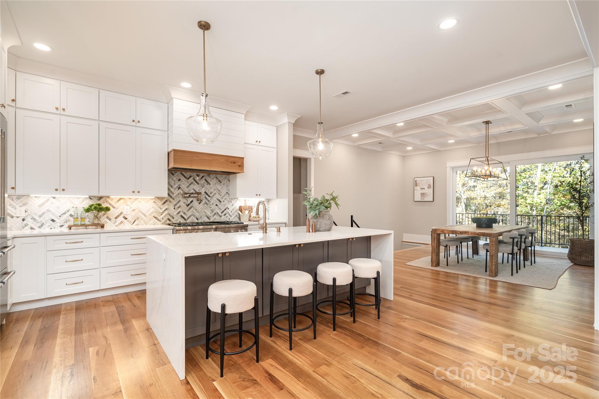 6632 Silver Fox Road Charlotte, NC 28270 - Photo 5 of 42 a kitchen with stainless steel appliances kitchen island granite countertop a table and chairs in it