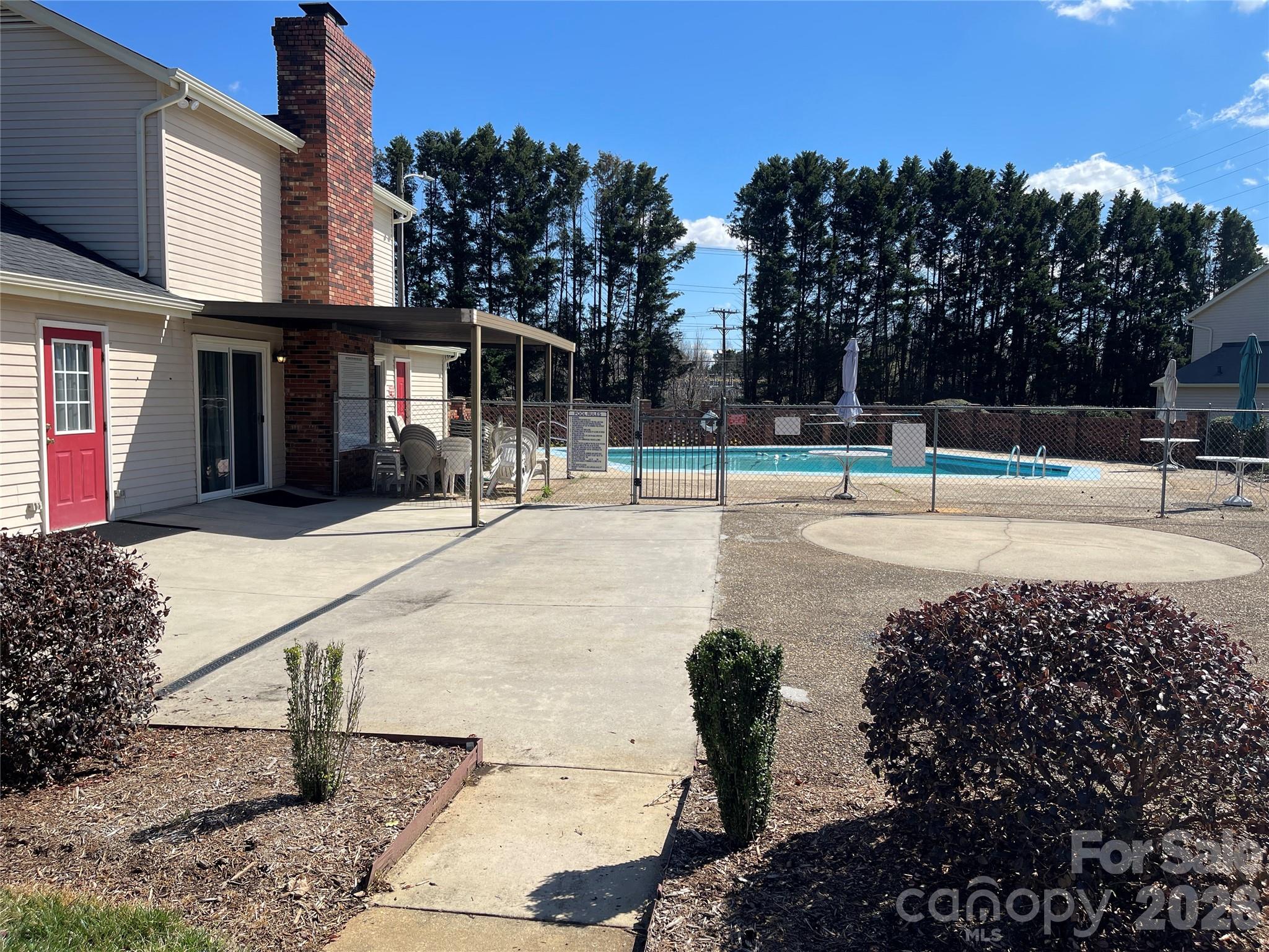 2705 North Center Street, Unit 36 Hickory, NC 28601 - Photo 20 of 21 a view of a swimming pool with a bench and trees