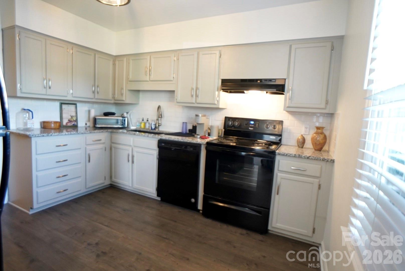 2705 North Center Street, Unit 36 Hickory, NC 28601 - Photo 3 of 21 a kitchen with granite countertop white cabinets and black appliances