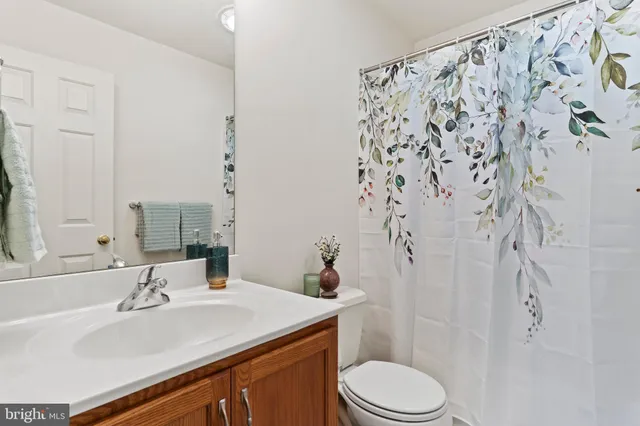 a view of a balcony with wooden floor and fence