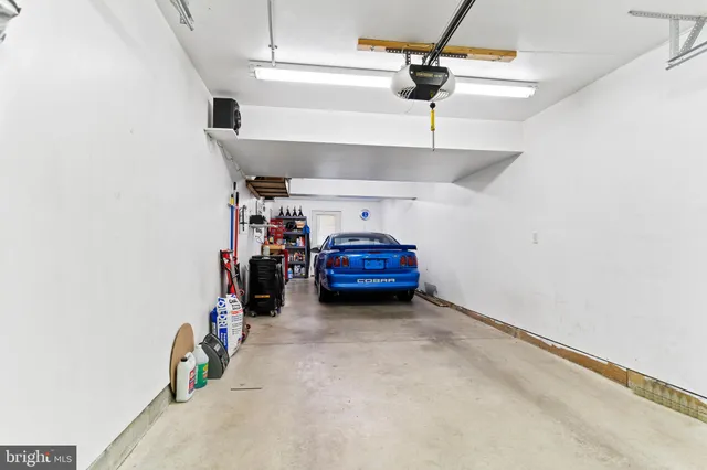 an aerial view of a house with a garden and lake view