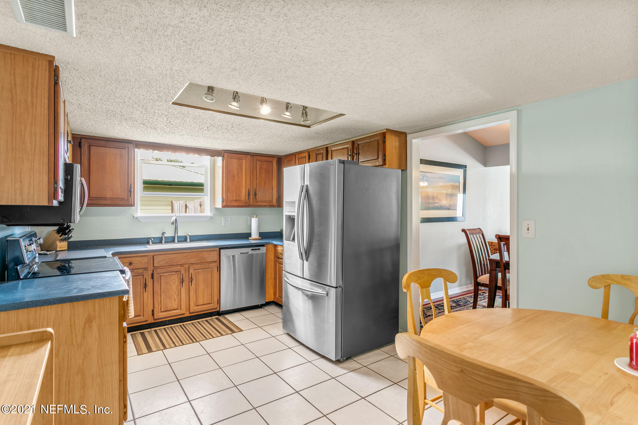 10841 Reading Road Jacksonville, FL 32257 - Photo 5 of 25 a kitchen with stainless steel appliances granite countertop a refrigerator and a stove top oven