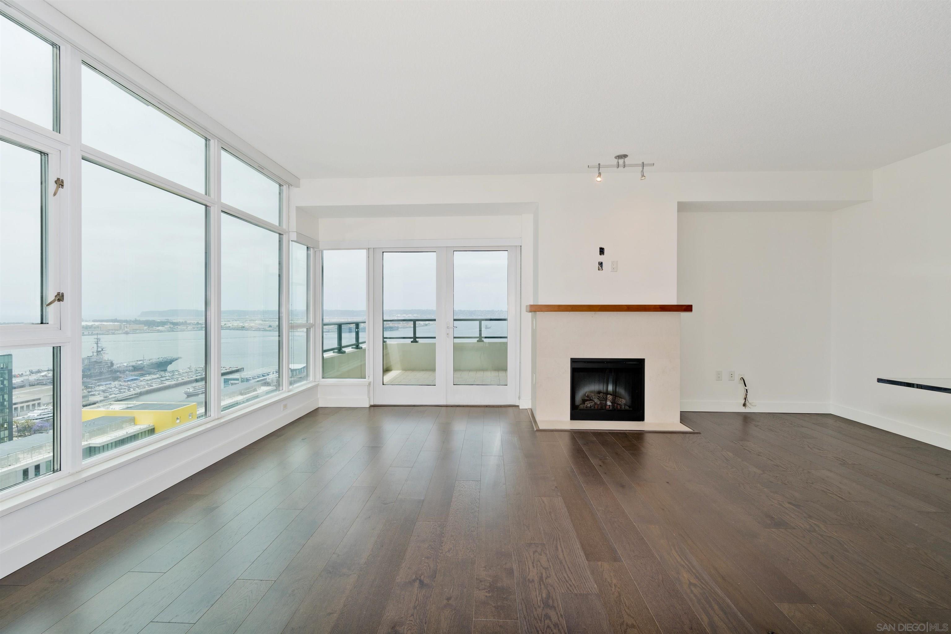 1205 Pacific Highway, Unit 2806 San Diego, CA 92101 - Photo 1 of 33 a view of an empty room with wooden floor and a window