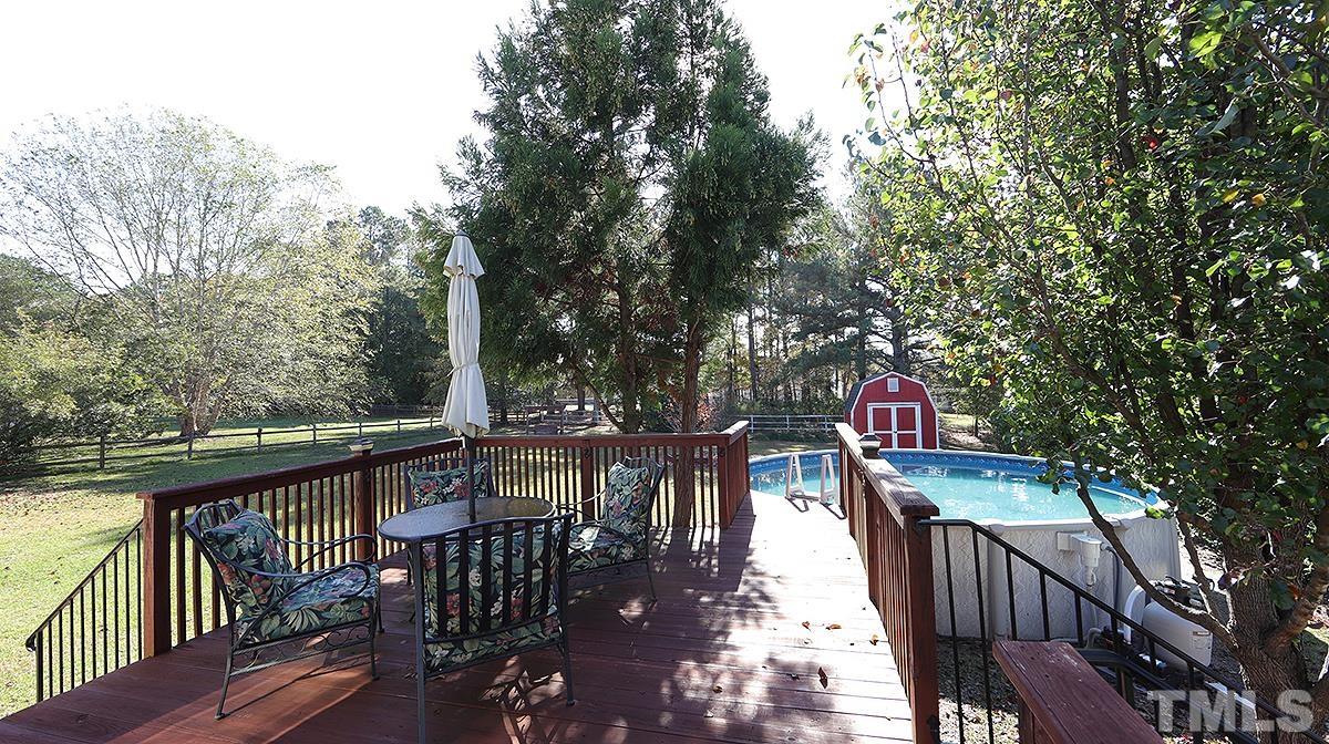 435 Ridge Road Angier, NC 27501 - Photo 8 of 29 Great view of deck with wrought iron railings. Large level lot with oversized storage building. Home features crawl space with new hot water heater.