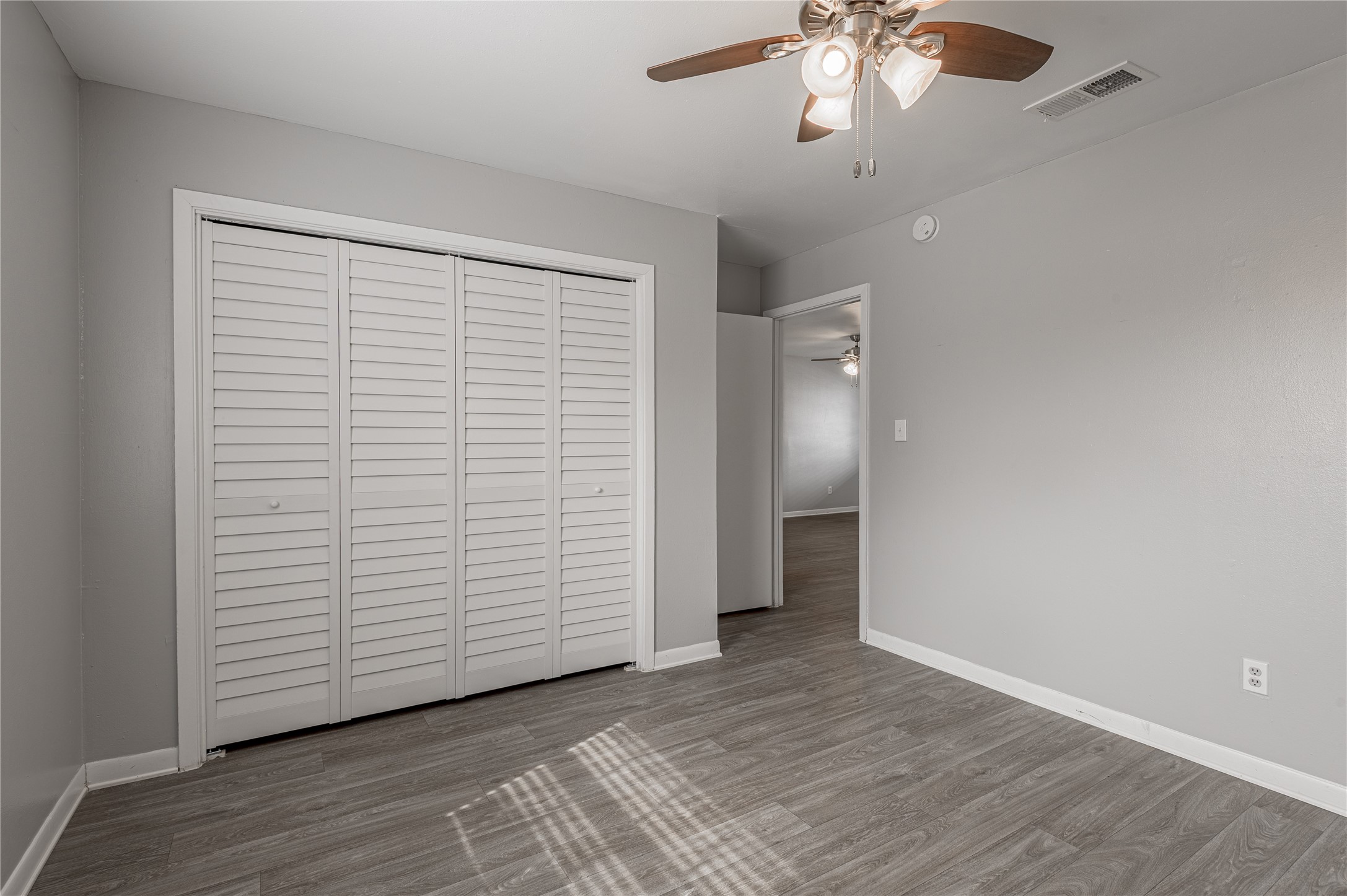 600 Palm Street, Unit 16 Huntsville, TX 77340 - Photo 12 of 21 wooden floor in an empty room with a window