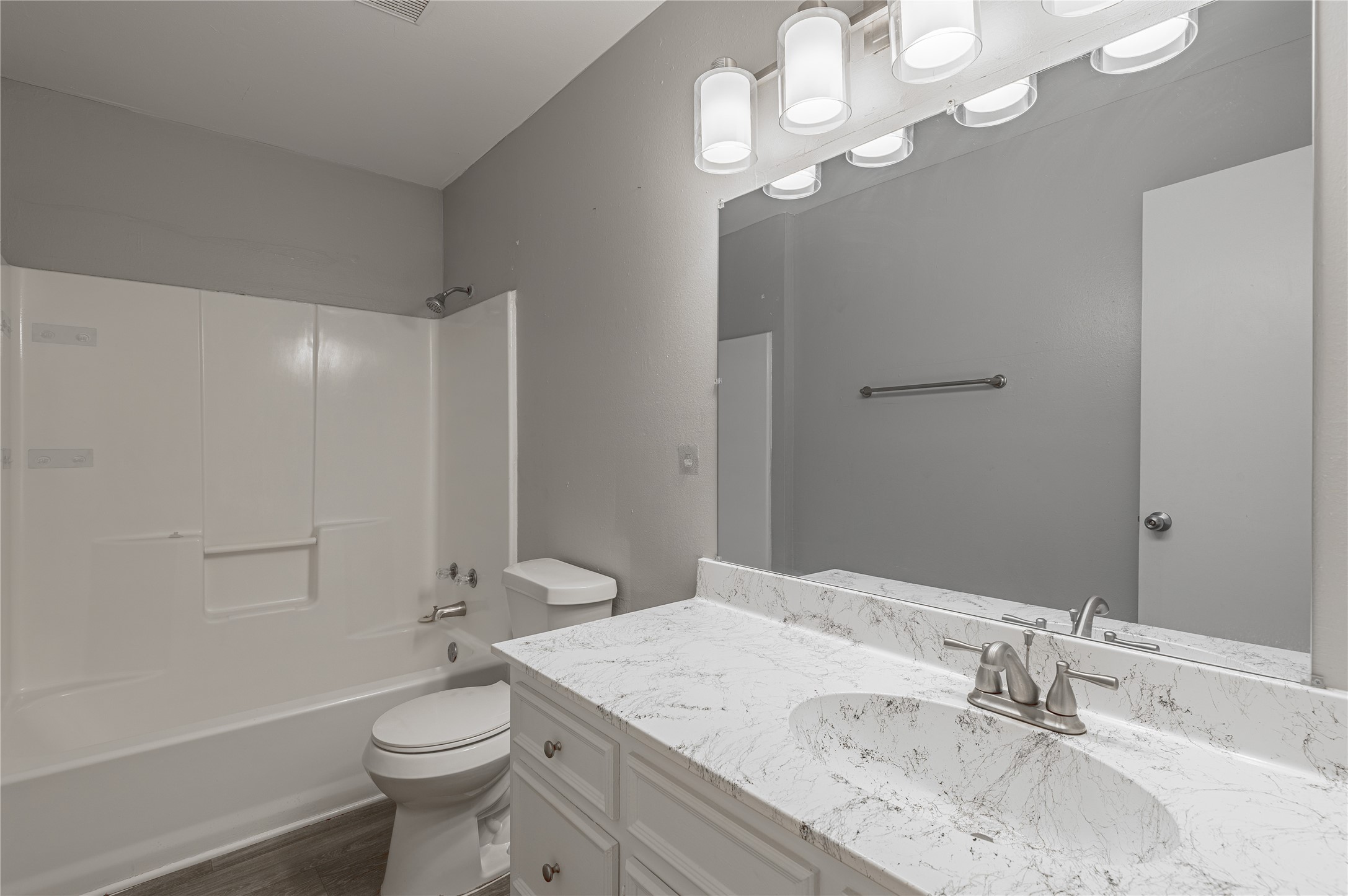600 Palm Street, Unit 16 Huntsville, TX 77340 - Photo 14 of 21 a bathroom with a granite countertop sink a toilet and shower