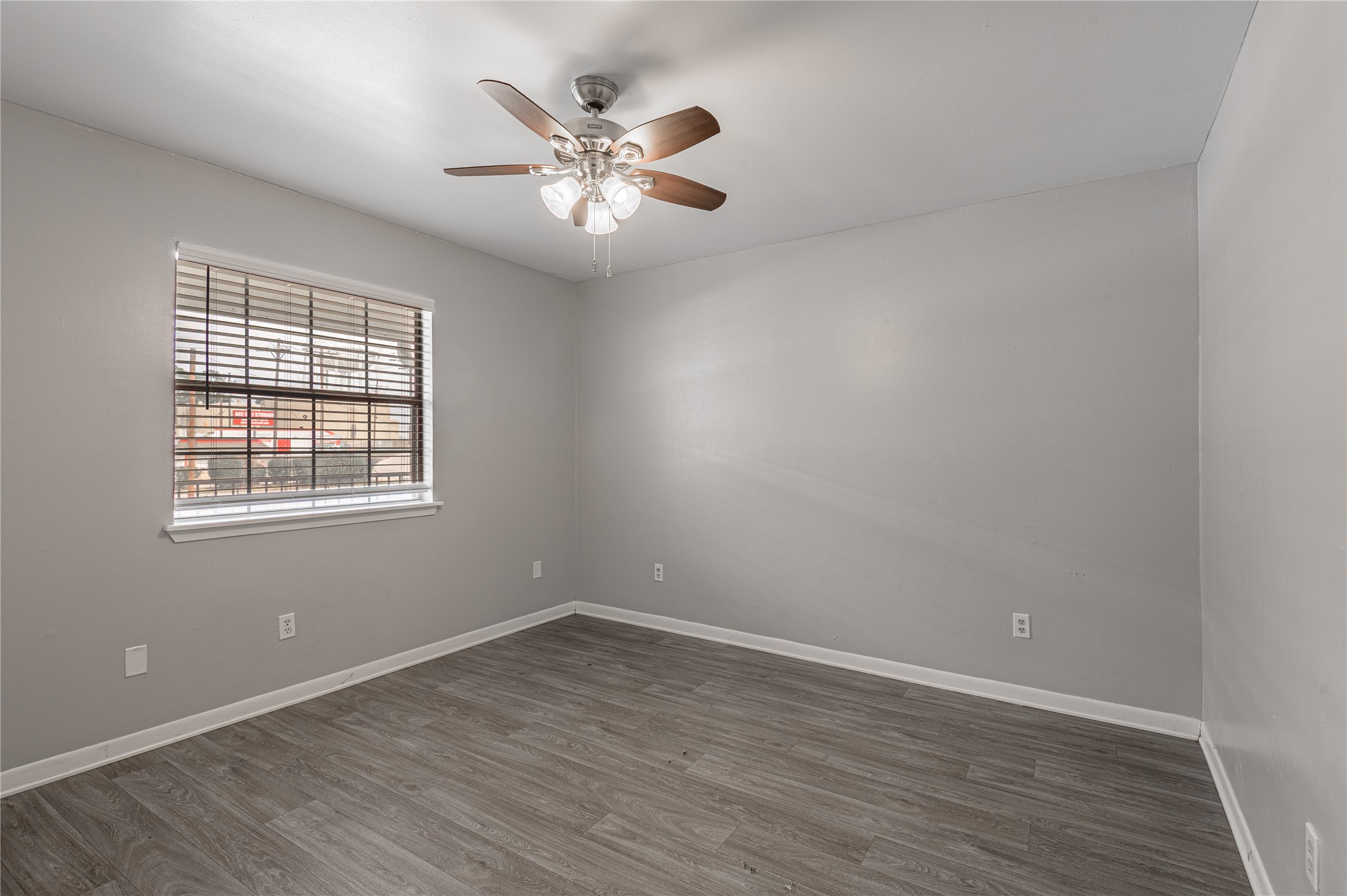 600 Palm Street, Unit 16 Huntsville, TX 77340 - Photo 15 of 21 a view of an empty room with wooden floor and a window