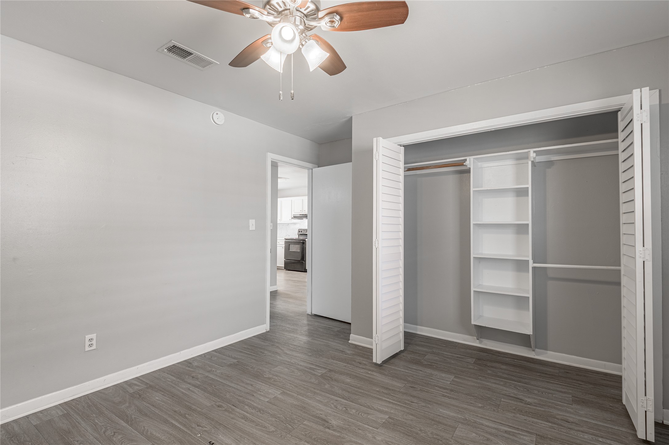 600 Palm Street, Unit 16 Huntsville, TX 77340 - Photo 18 of 21 a view of an empty room with a window and wooden floor