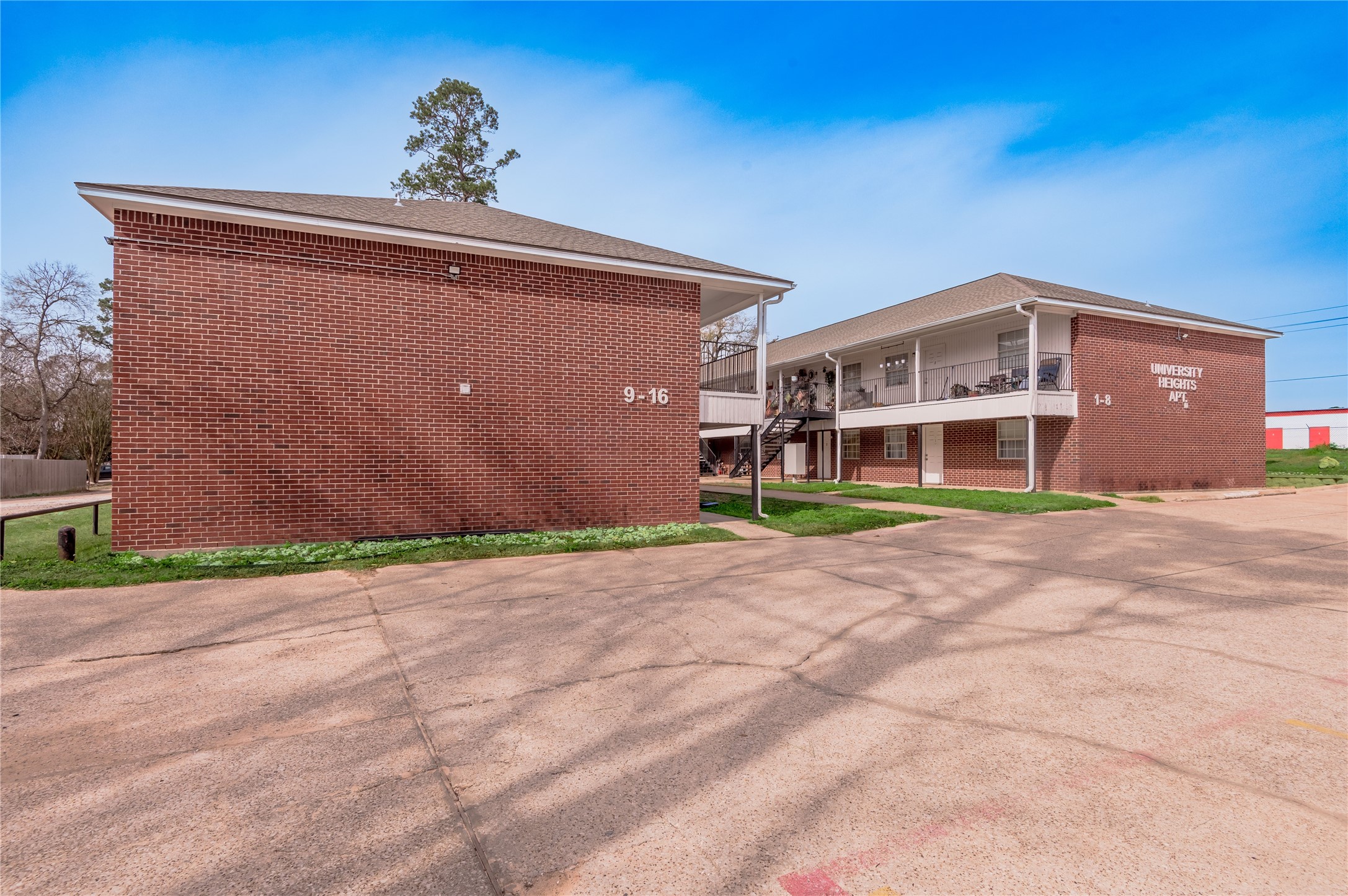 600 Palm Street, Unit 16 Huntsville, TX 77340 - Photo 20 of 21 a front view of a house with a yard and garage