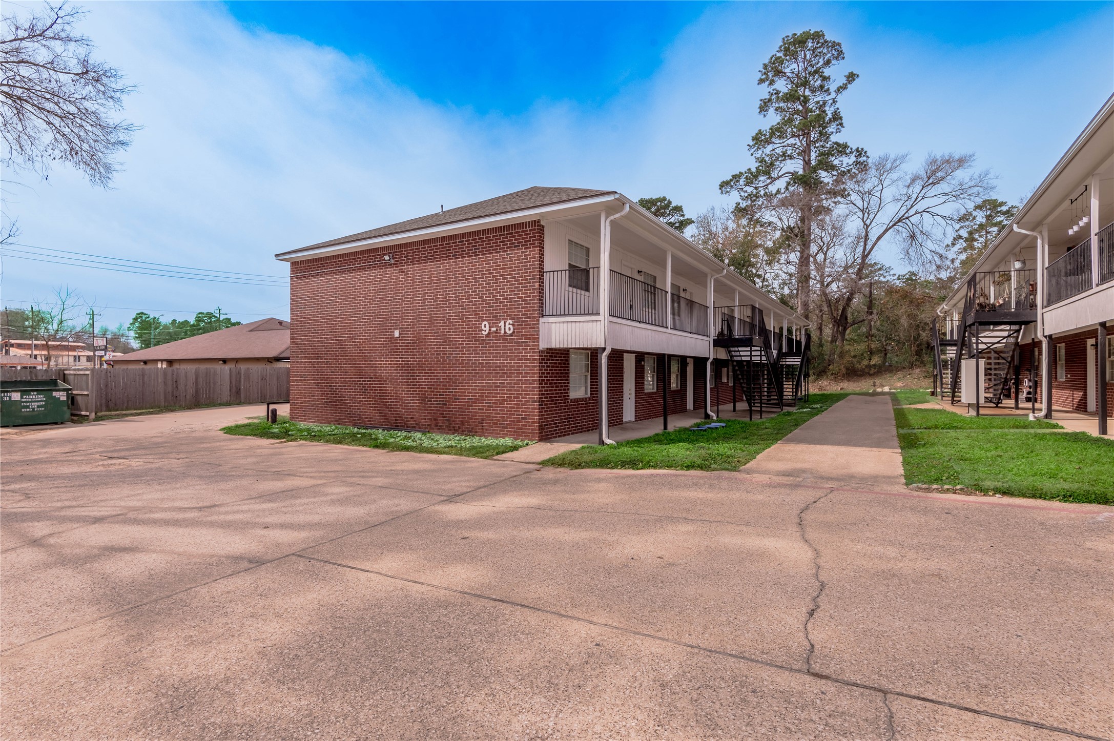 600 Palm Street, Unit 16 Huntsville, TX 77340 - Photo 21 of 21 a front view of a house with a yard and a garage