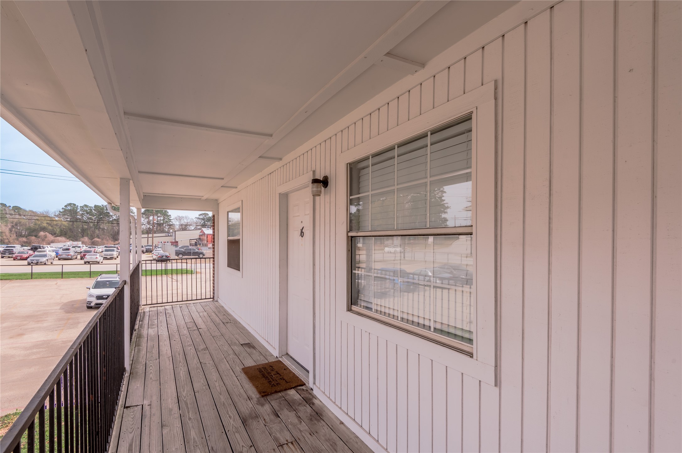 600 Palm Street, Unit 16 Huntsville, TX 77340 - Photo 3 of 21 a view of a balcony with wooden floor and outdoor space