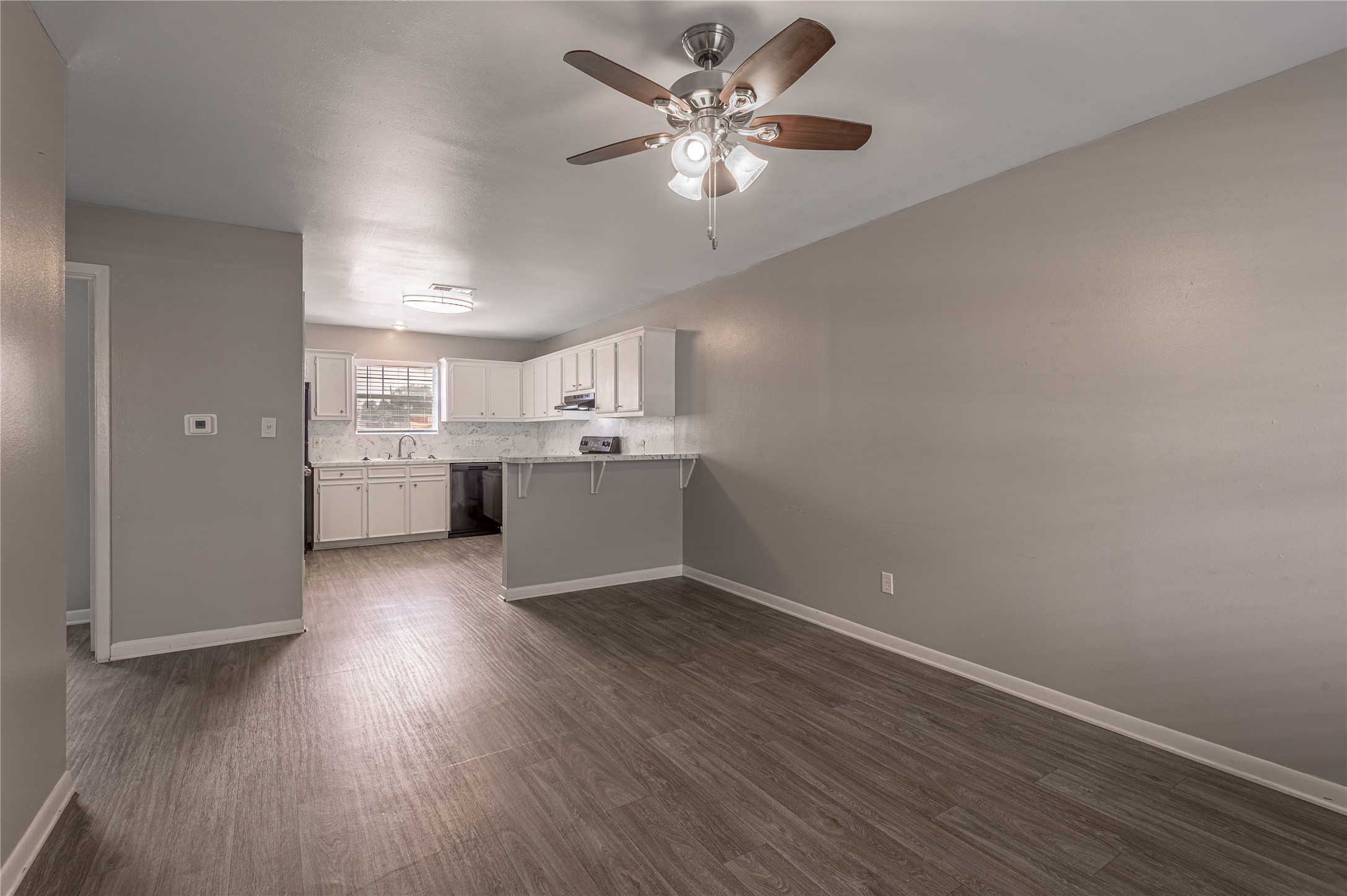 600 Palm Street, Unit 16 Huntsville, TX 77340 - Photo 4 of 21 a view of an empty room with a kitchen and a window