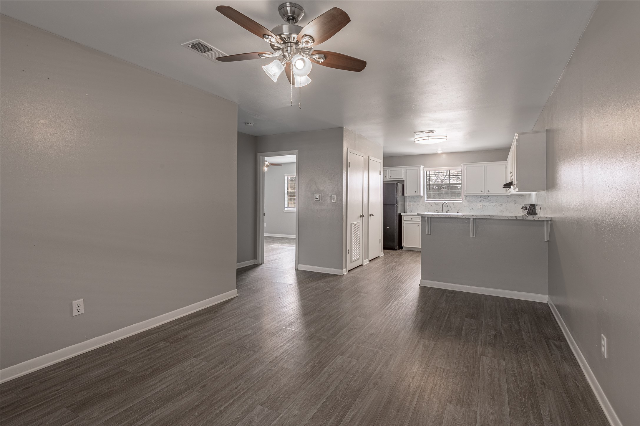 600 Palm Street, Unit 16 Huntsville, TX 77340 - Photo 5 of 21 a view of a kitchen with a dishwasher cabinets and wooden floor