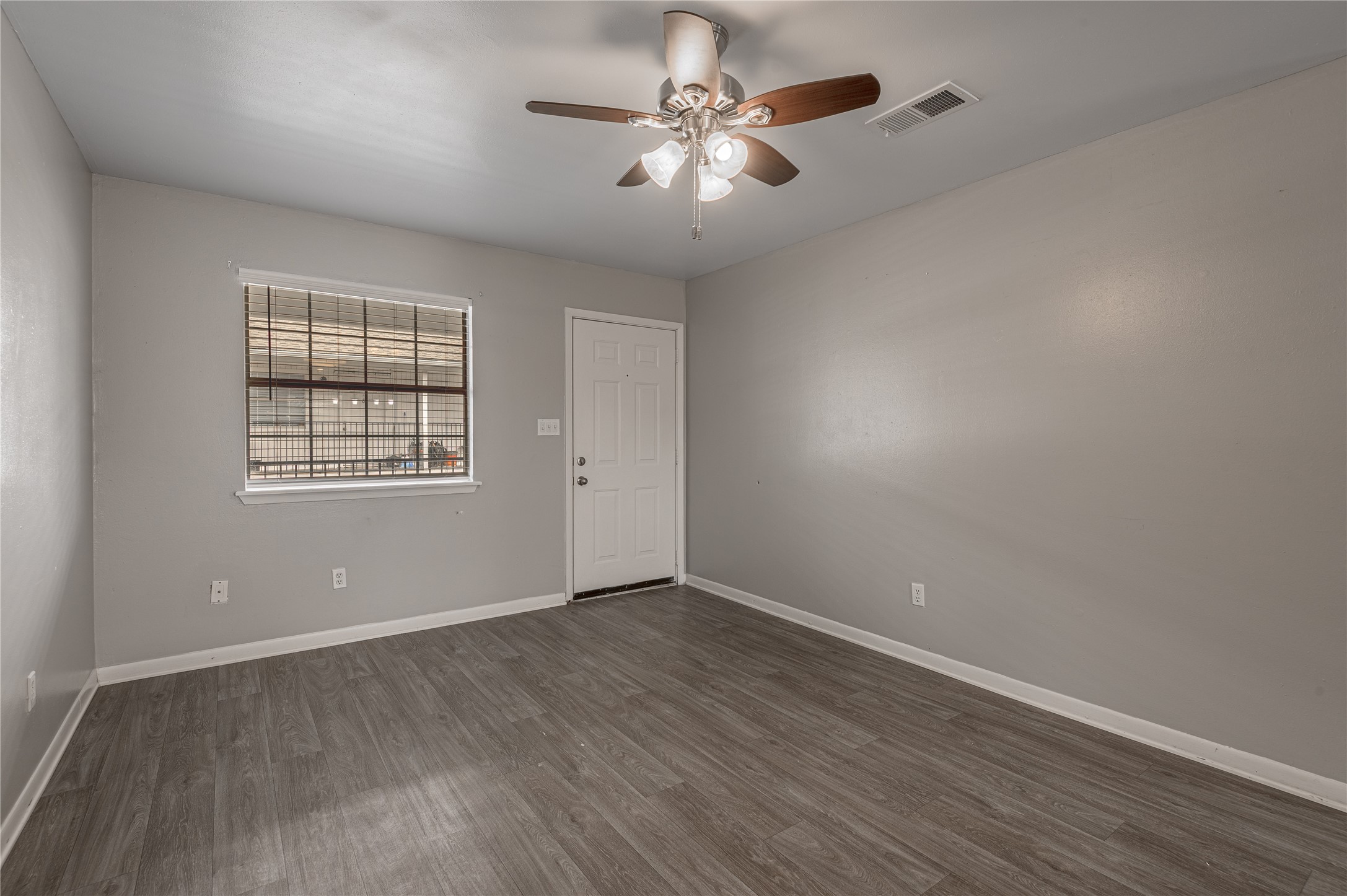 600 Palm Street, Unit 16 Huntsville, TX 77340 - Photo 6 of 21 wooden floor in an empty room with a window