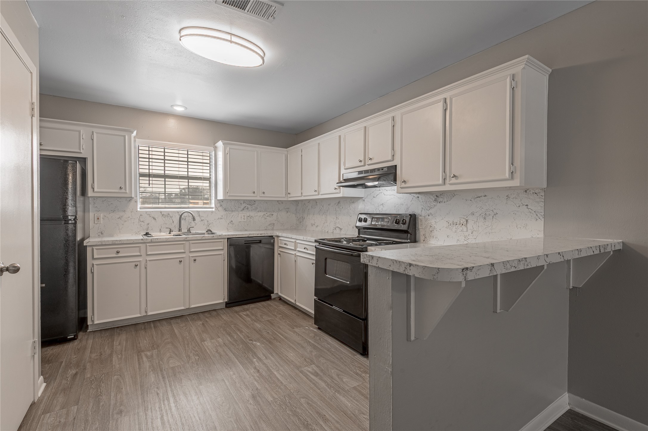 600 Palm Street, Unit 16 Huntsville, TX 77340 - Photo 7 of 21 a kitchen with a sink white cabinets and stainless steel appliances