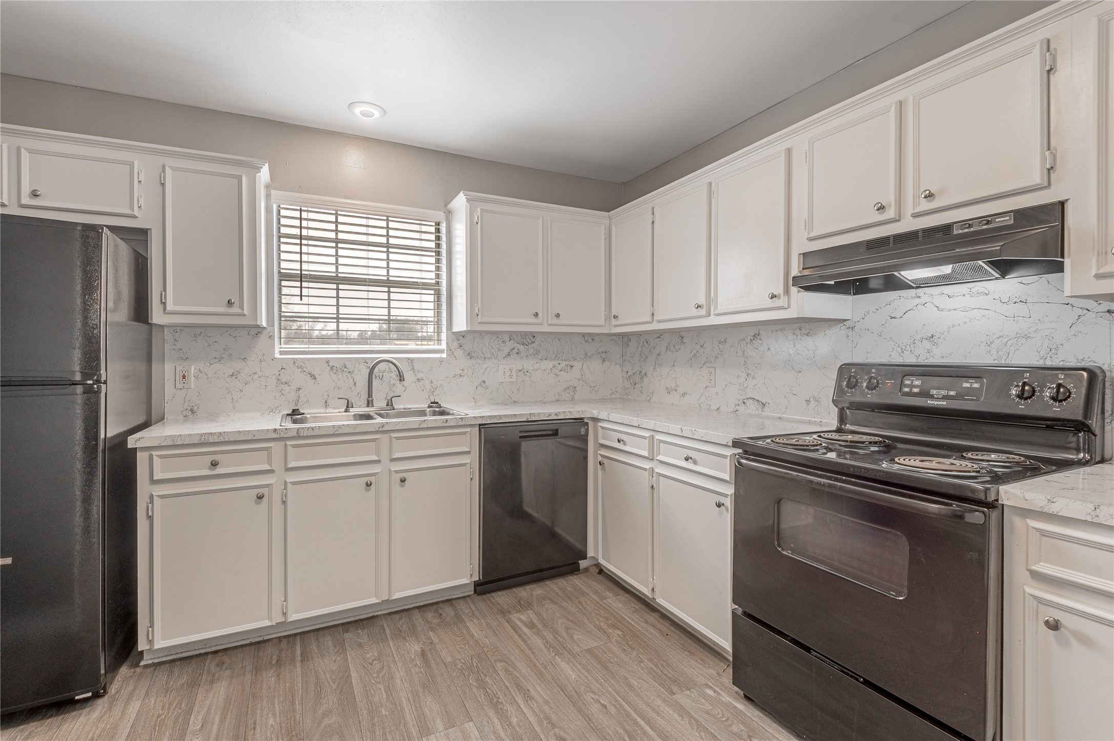 600 Palm Street, Unit 16 Huntsville, TX 77340 - Photo 8 of 21 a kitchen with cabinets appliances a sink and a window