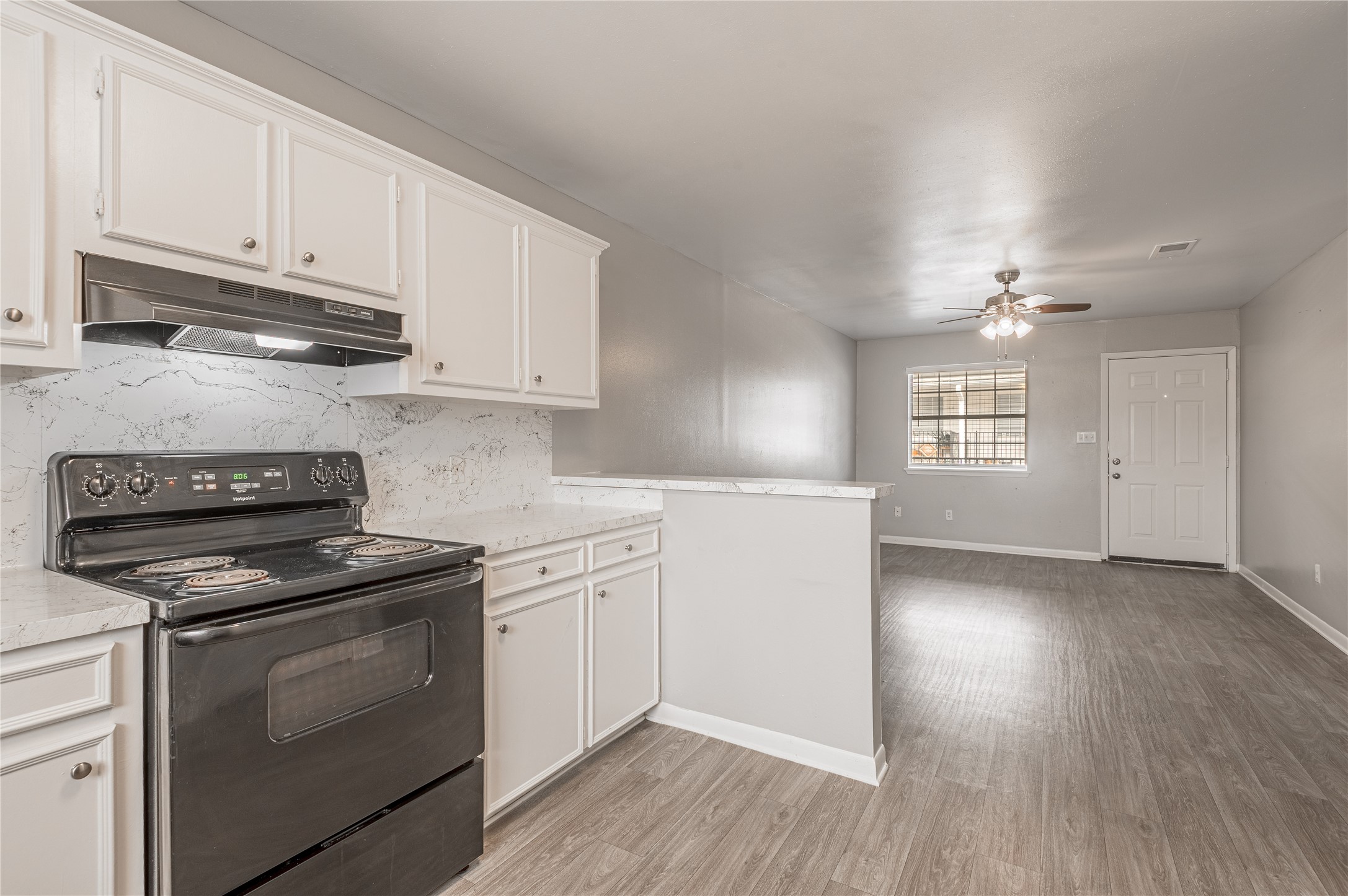 600 Palm Street, Unit 16 Huntsville, TX 77340 - Photo 9 of 21 a kitchen with granite countertop white cabinets and white appliances