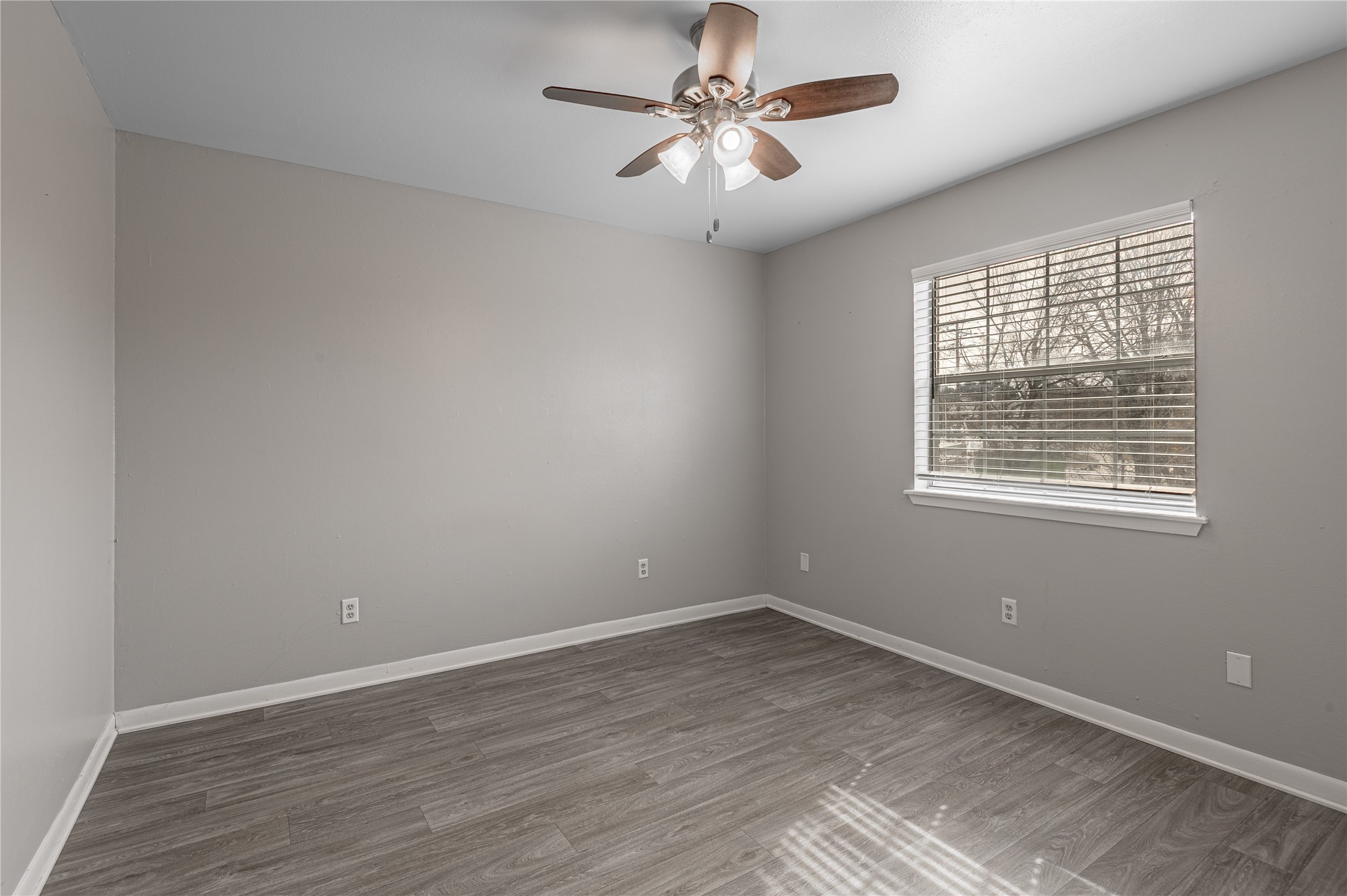 600 Palm Street, Unit 16 Huntsville, TX 77340 - Photo 10 of 21 wooden floor in an empty room with a window