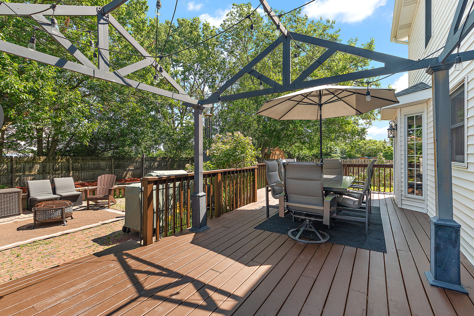 24929 Vermette Road Plainfield, IL 60585 - Photo 24 of 31 a view of deck with table and chairs under an umbrella