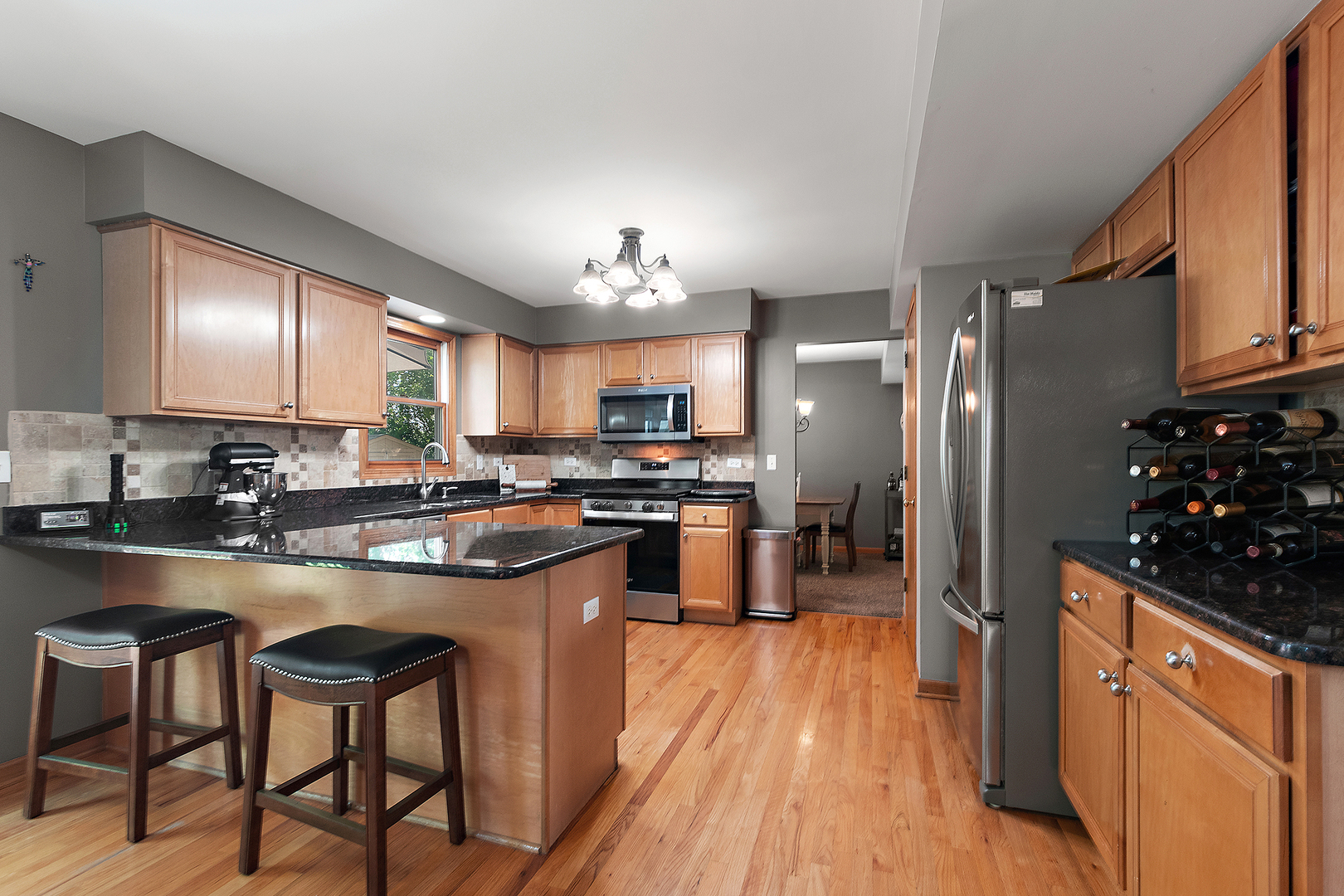 24929 Vermette Road Plainfield, IL 60585 - Photo 8 of 31 a kitchen with refrigerator a sink and chairs