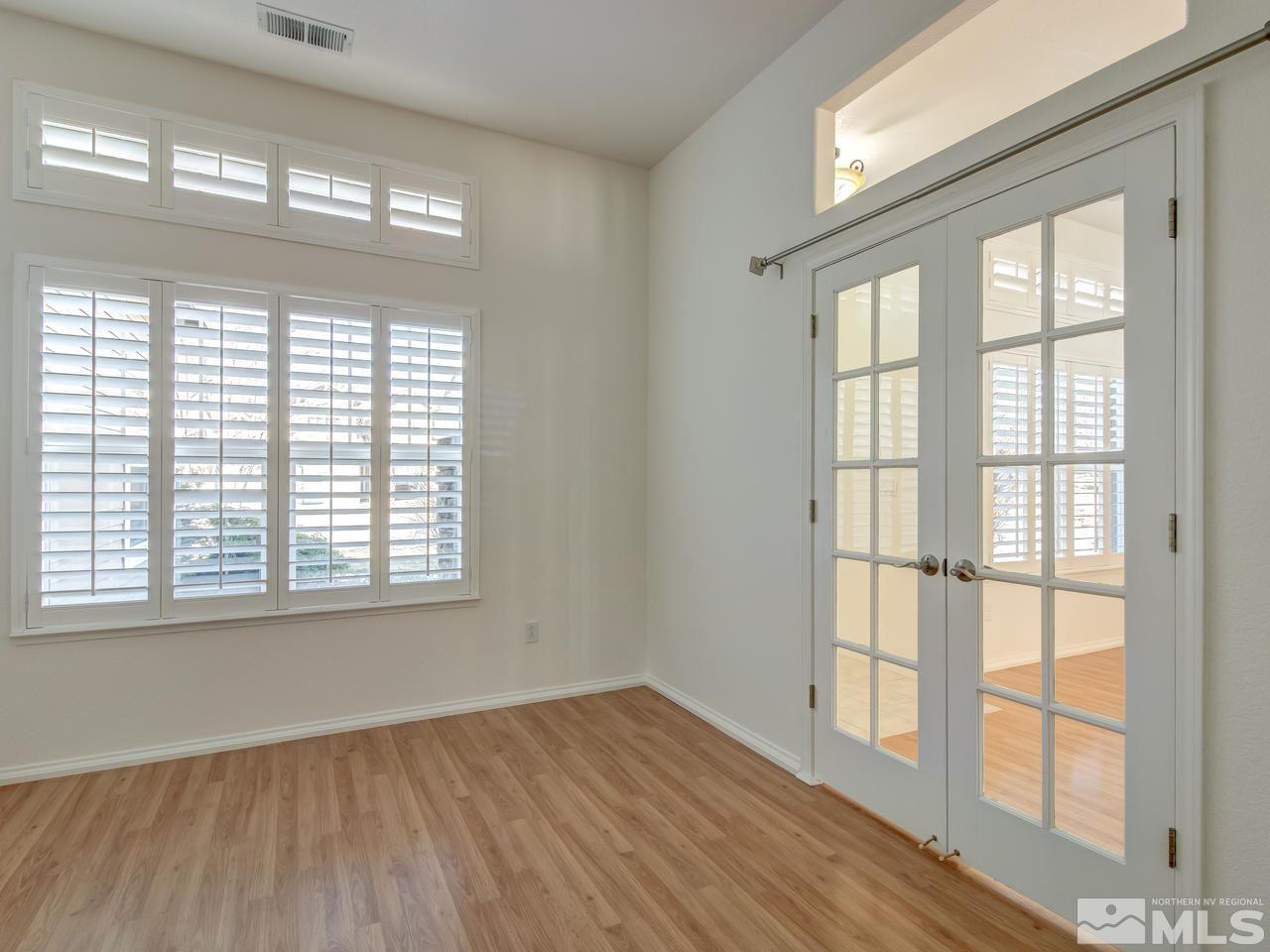 9350 Oakley Court Reno, NV 89521 - Photo 3 of 19 a view of an empty room with wooden floor and a window