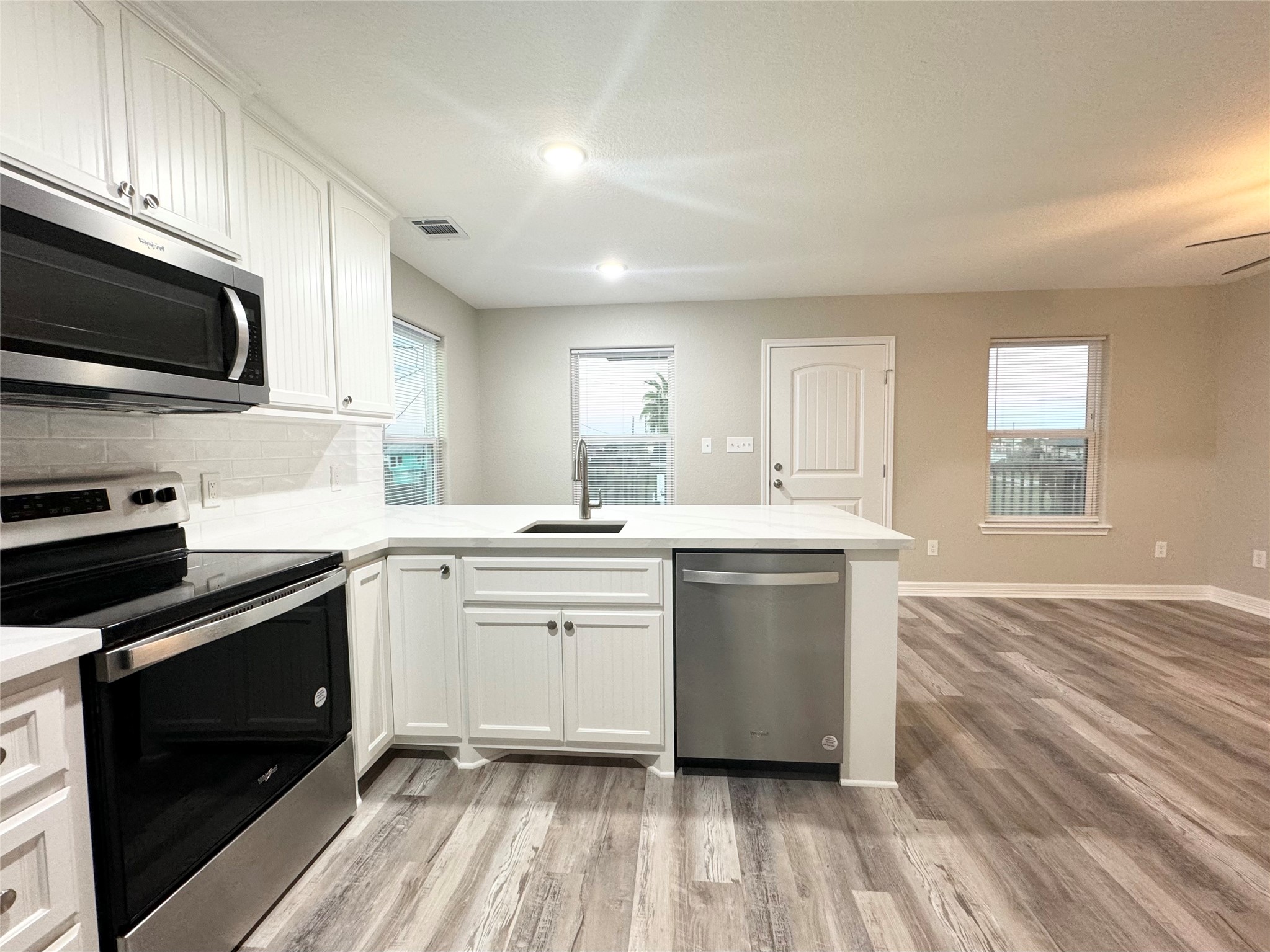 511 Caisson Street Surfside Beach, TX 77541 - Photo 11 of 33 a kitchen with a sink stove and microwave