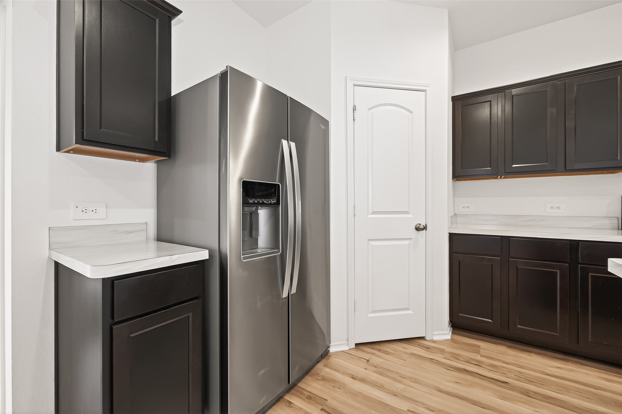 21522 Violet Ridge Road Katy, TX 77449 - Photo 16 of 39 Sleek, dark cabinets, stainless steel appliances, and light wood flooring, offering a clean, contemporary look.