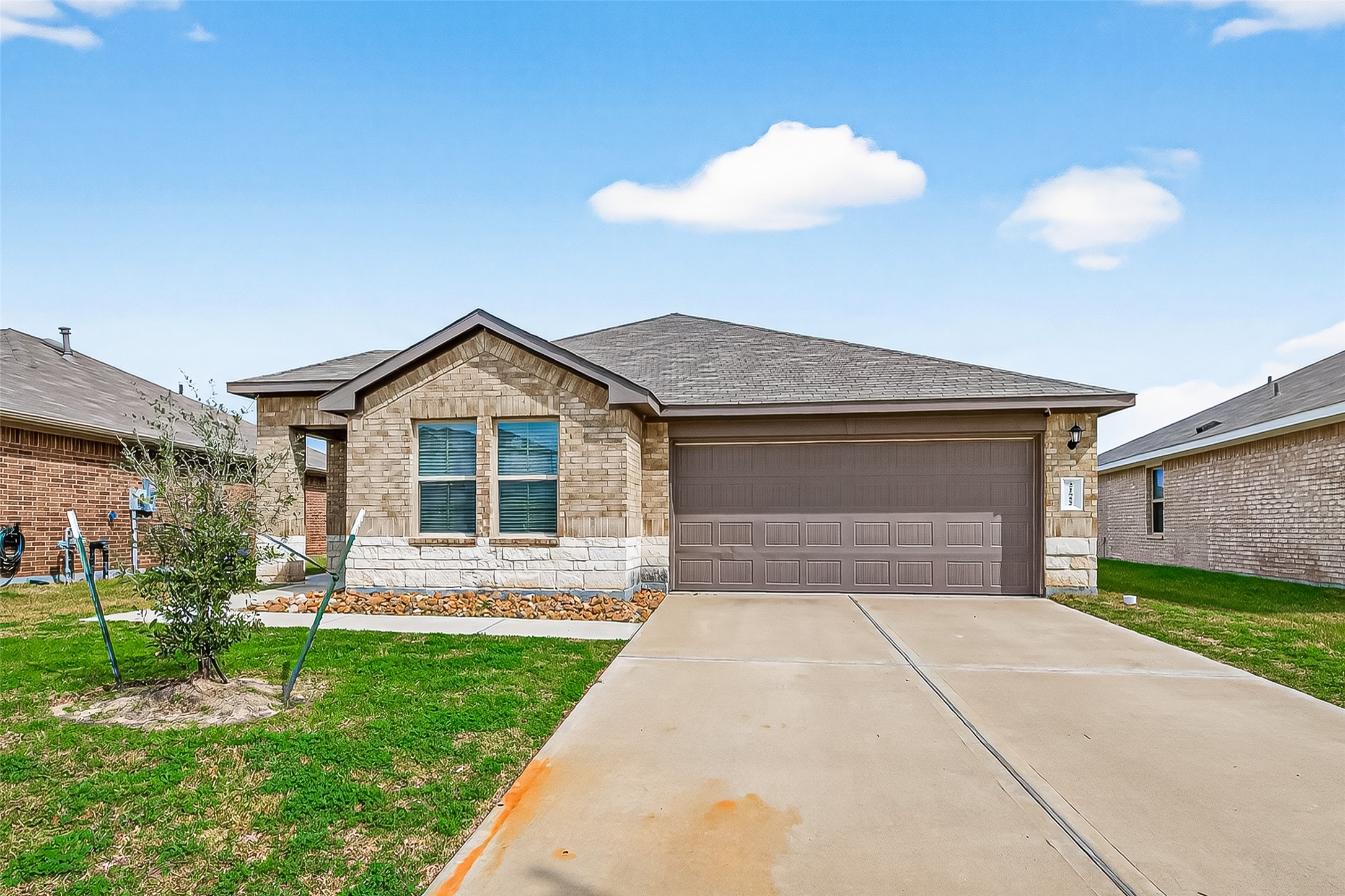 21522 Violet Ridge Road Katy, TX 77449 - Photo 2 of 39 The warm tone elevation and a spacious driveway, offering ample parking for your guests.