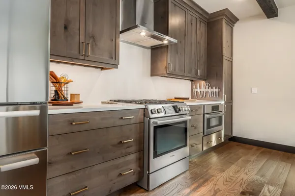 a kitchen with stainless steel appliances granite countertop a stove and a microwave