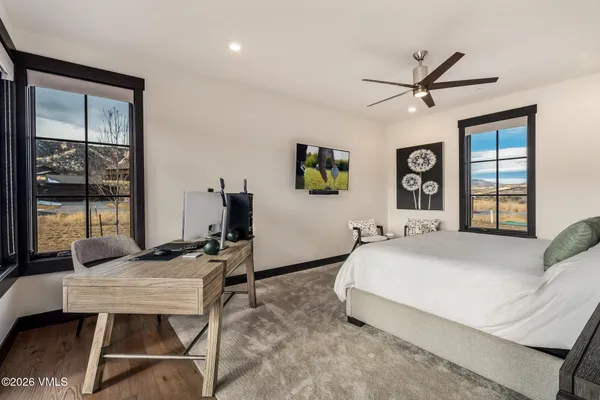 a bedroom with a bed window and wall painting