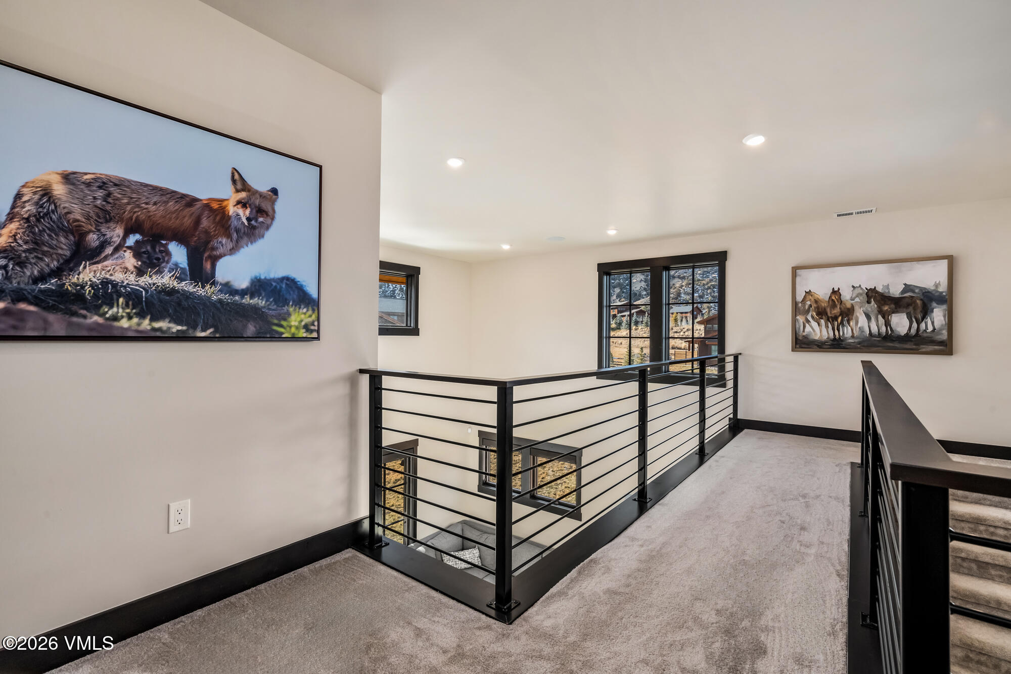580 Hunters View Lane Eagle, CO 81631 - Photo 20 of 33 a view of a hallway with a large mirror and paintings on the wall