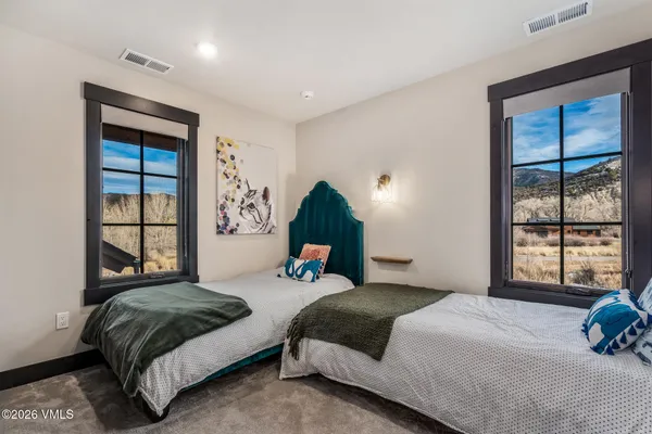 a bedroom with a large bed and a window