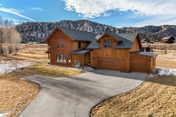 a view of a house next to a yard