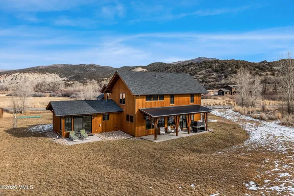 a view of a house with a yard and sitting area
