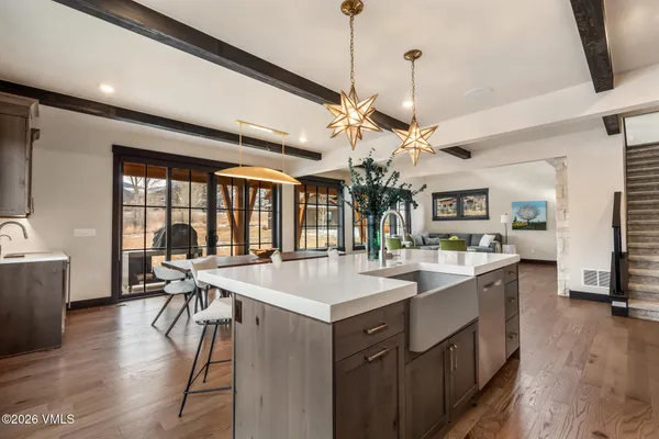 a large kitchen with a table and chairs