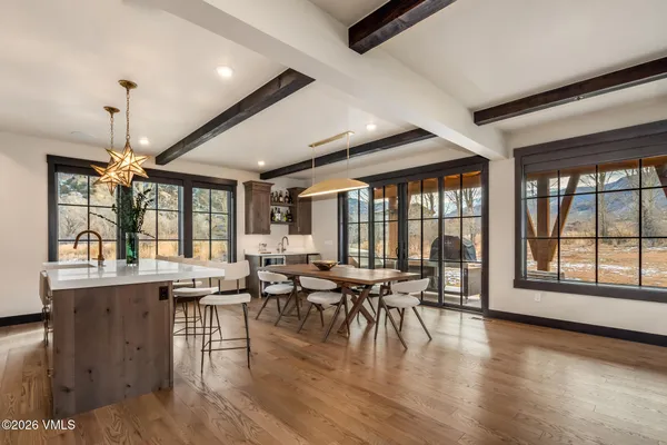a view of a dining room with furniture window and wooden floor