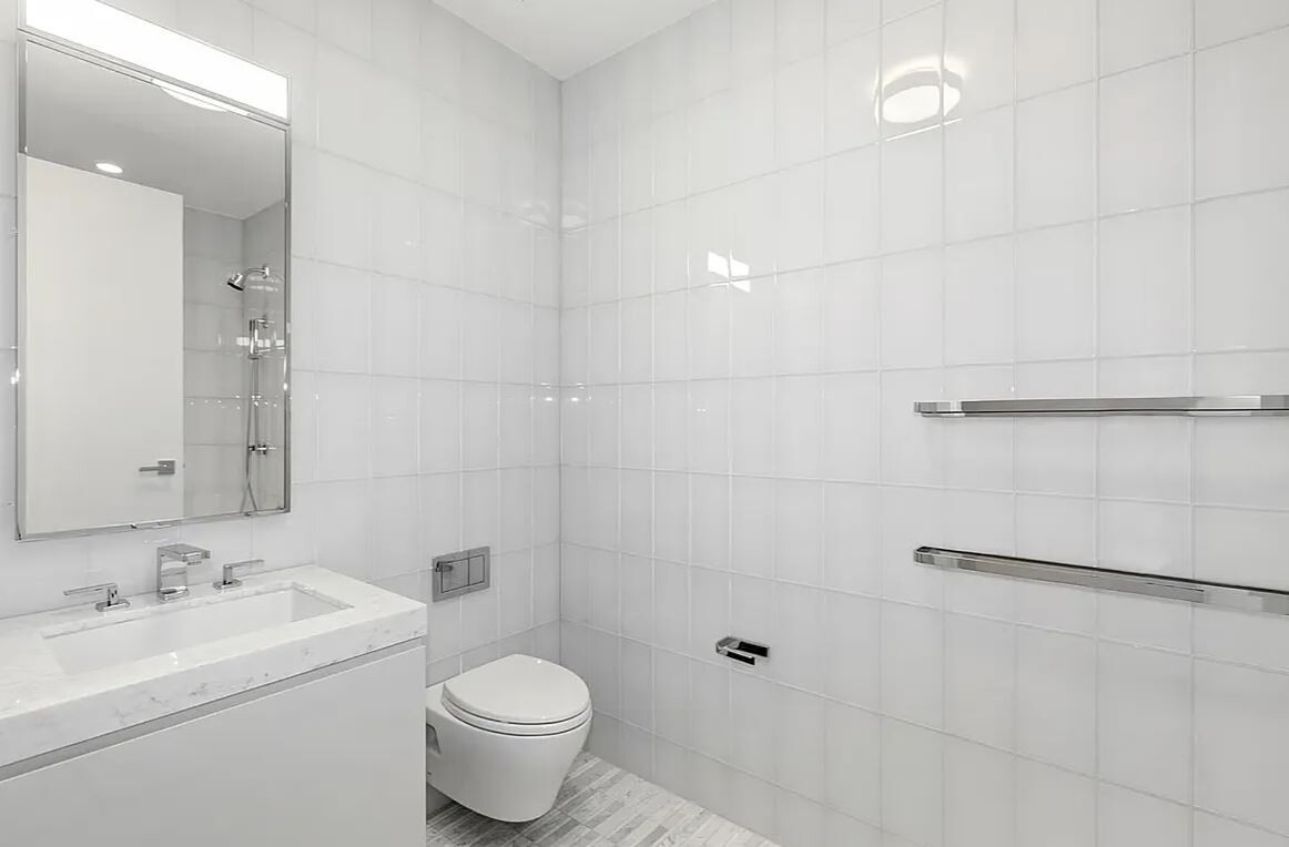 50 West 66th Street, Unit 9G Manhattan, NY 10023 - Photo 12 of 13 a bathroom with a sink toilet and shower