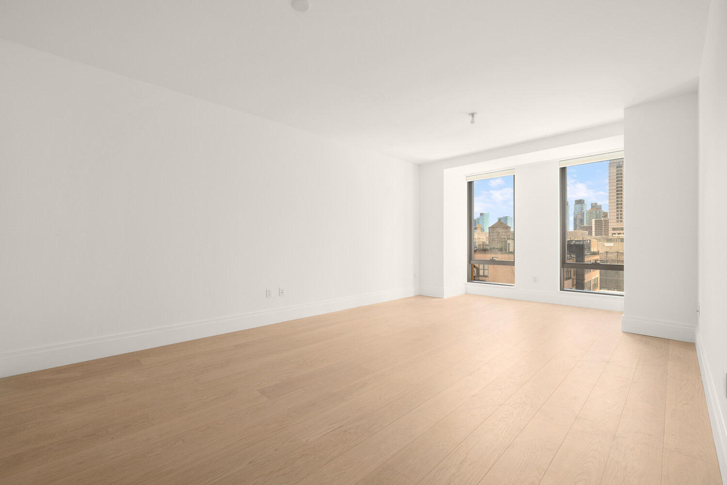 50 West 66th Street, Unit 9G Manhattan, NY 10023 - Photo 2 of 13 an empty room with windows