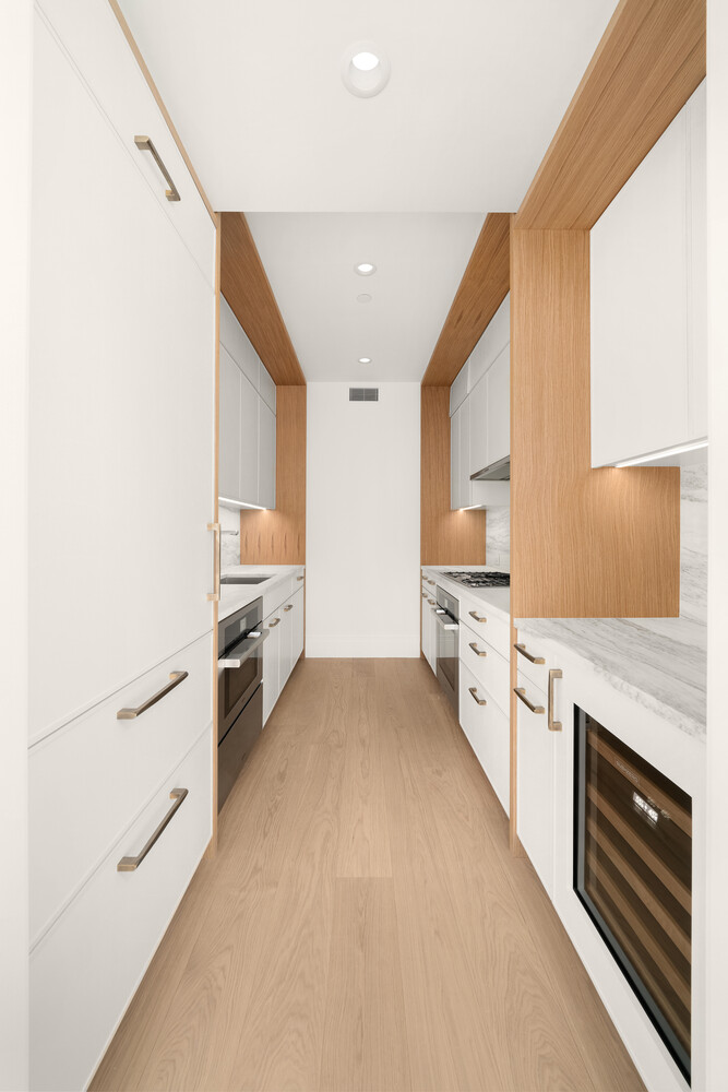 50 West 66th Street, Unit 9G Manhattan, NY 10023 - Photo 4 of 13 a kitchen with granite countertop a sink stainless steel appliances and cabinets