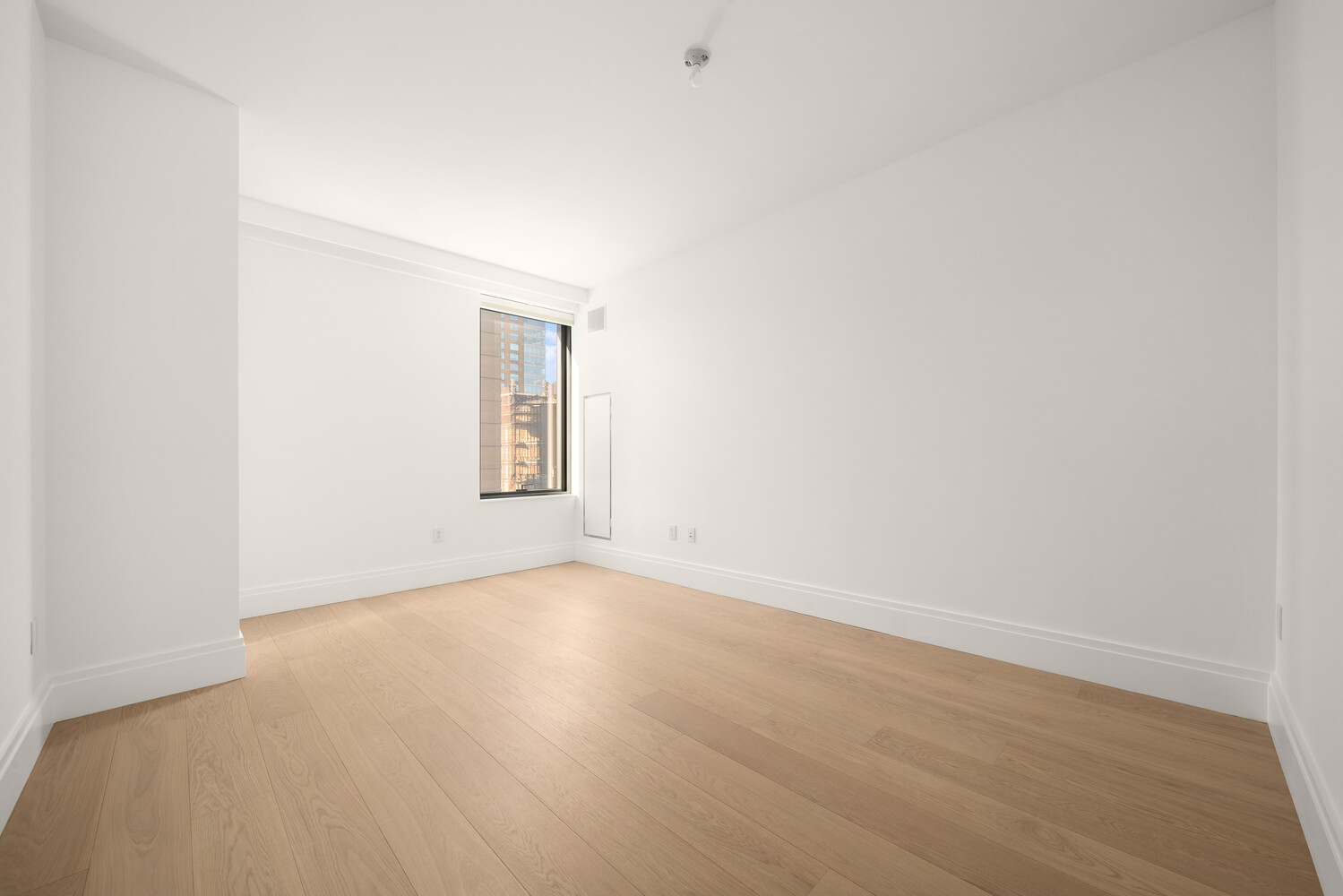 50 West 66th Street, Unit 9G Manhattan, NY 10023 - Photo 8 of 13 a view of an empty room with a window