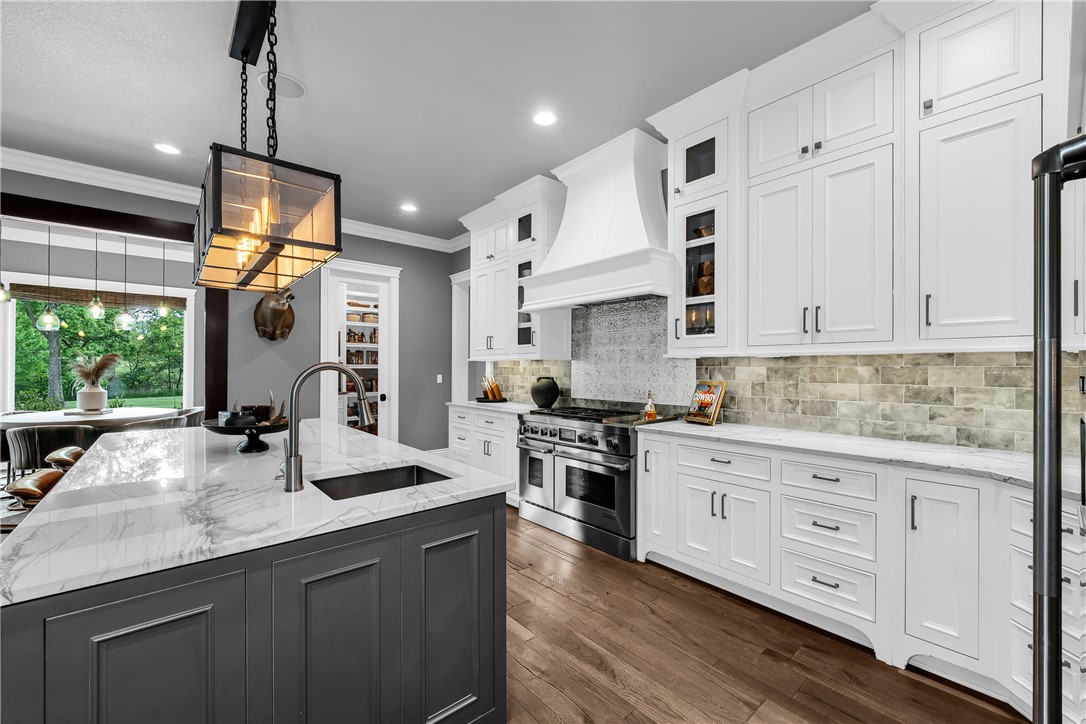 3510 Copper Ridge Road Rogers, AR 72756 - Photo 42 of 58 This kitchen features an island with a light-colored countertop and an undermount sink